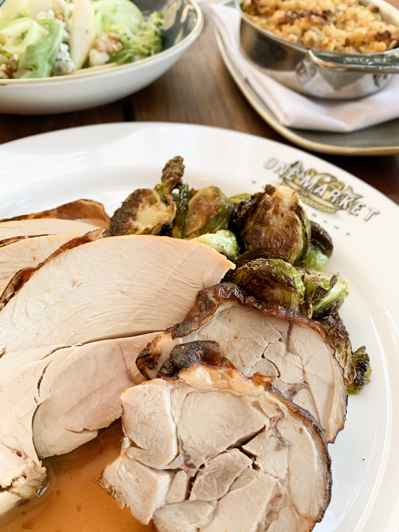 A plate of turkey and Brussel sprouts on a One Market dinner plate. 