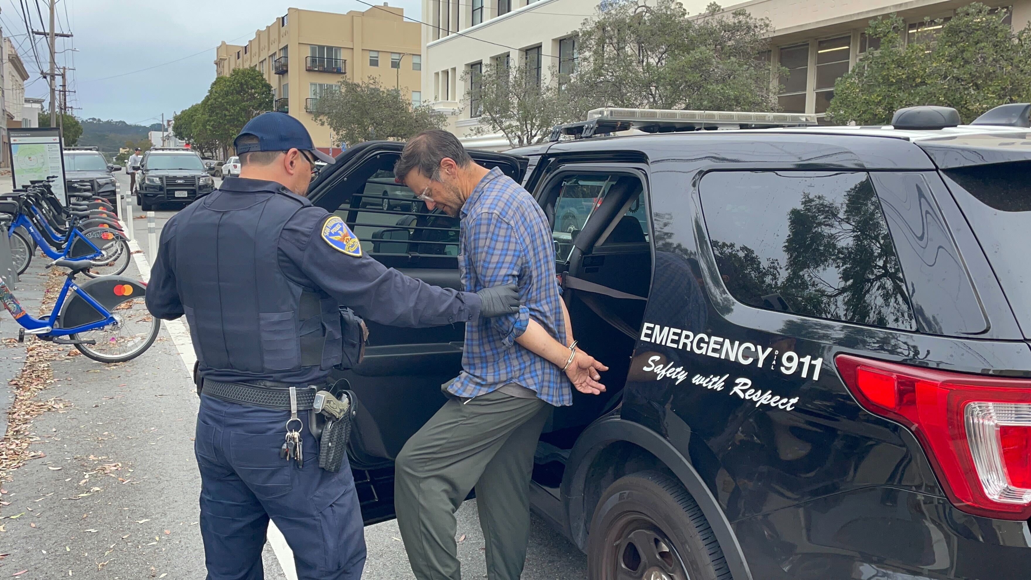 A man is arrested by police.