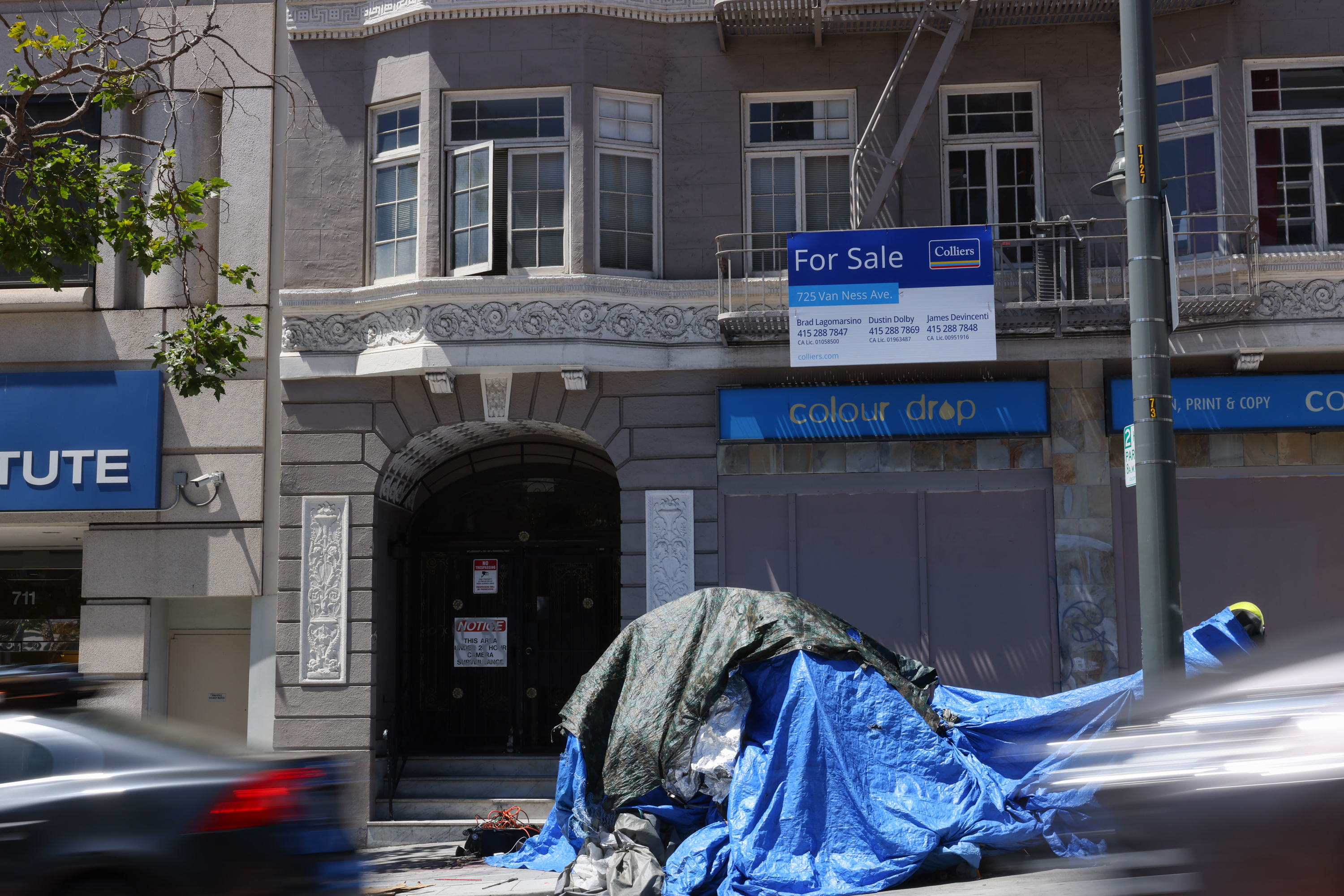 Tent in front of San Francisco building listed for sale.