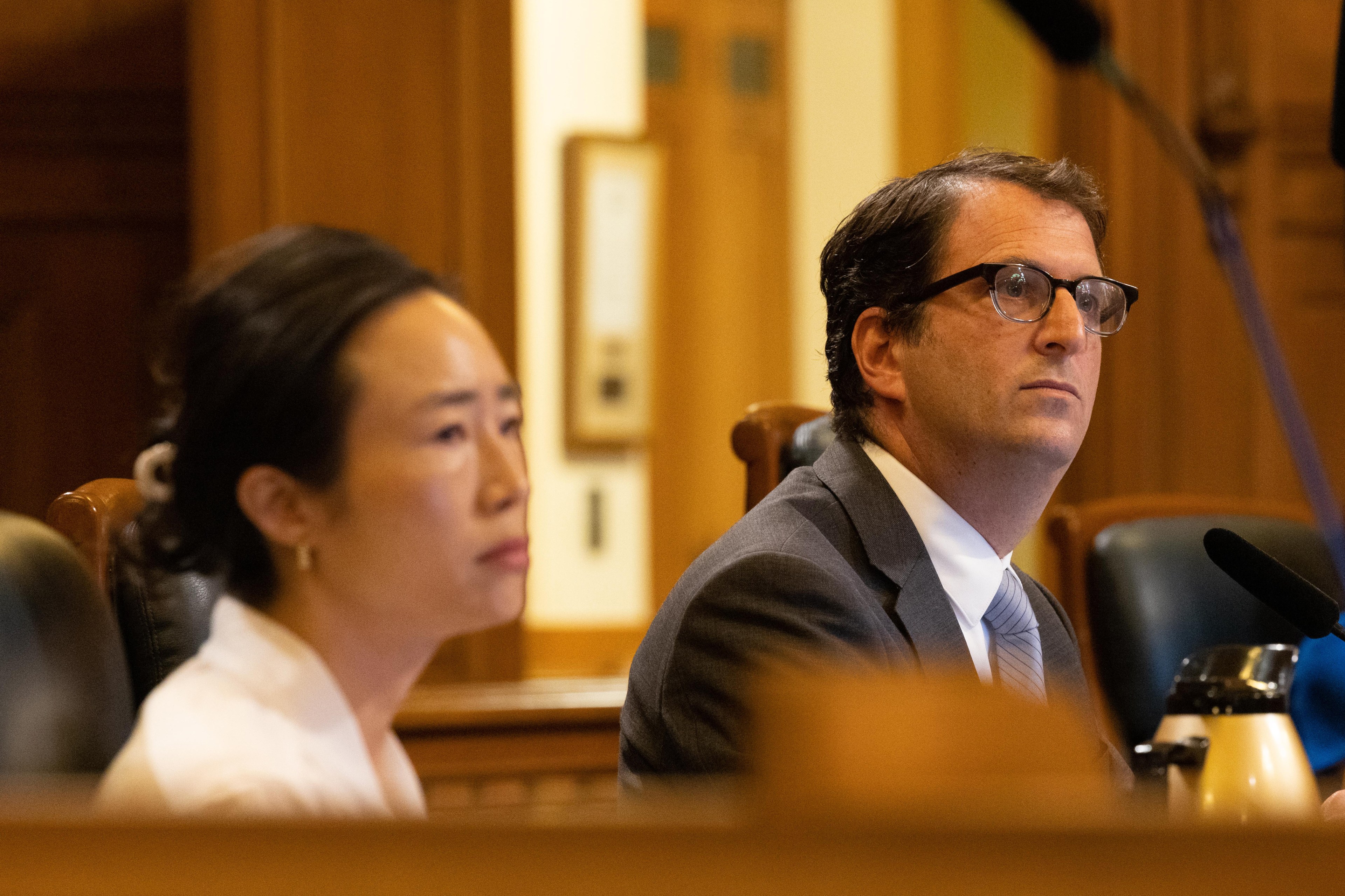Supervisors Connie Chan and Dean Preston listen during a hearing at City Hall in San Francisco.