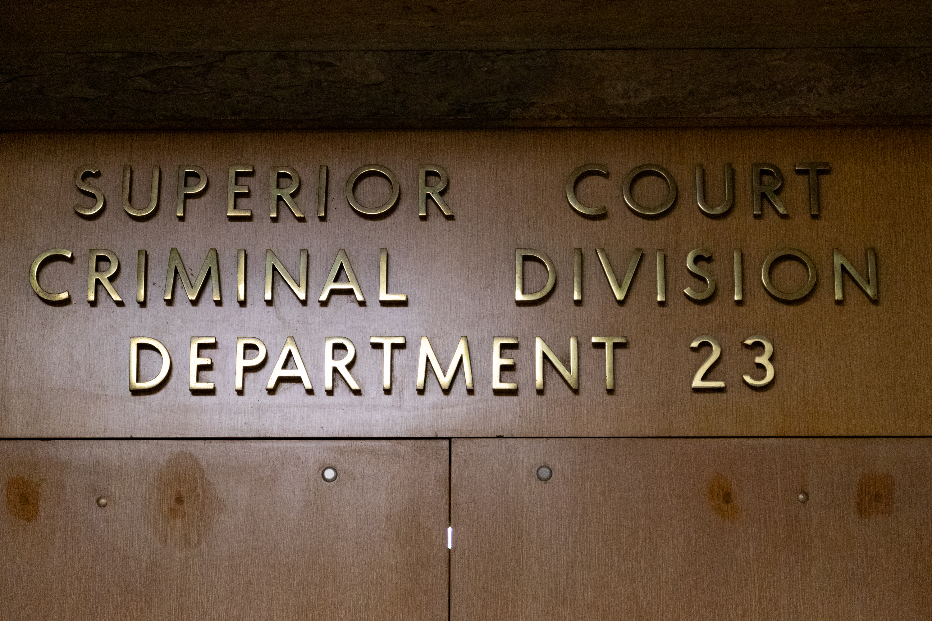 Gold lettering above double door reads Superior Court Criminal Division Department 23