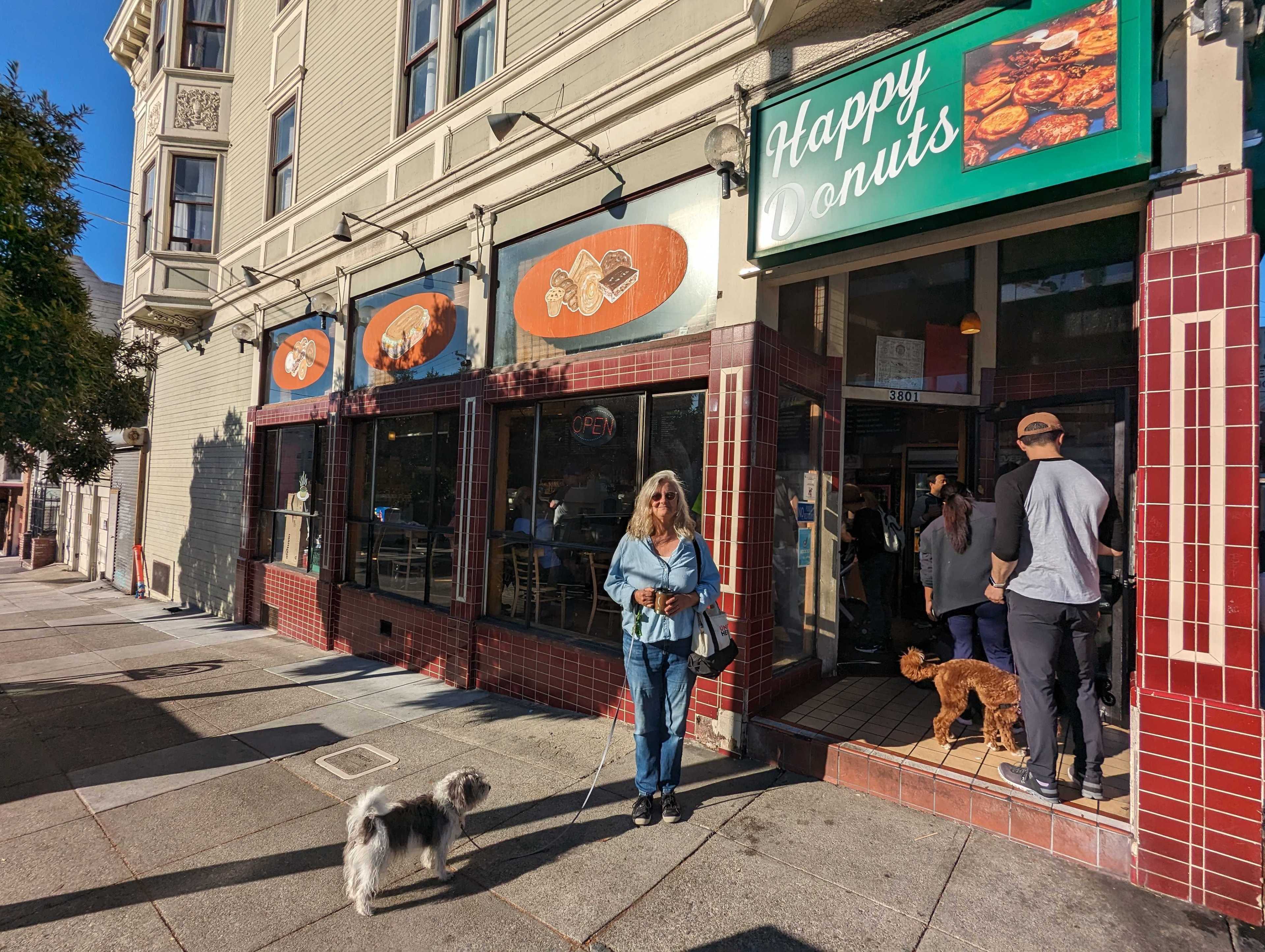 Lisa Jaicks, a neighborhood resident and Happy Donuts regular, visited the shop Wednesday with her dog Louie Jaicks-Gable.