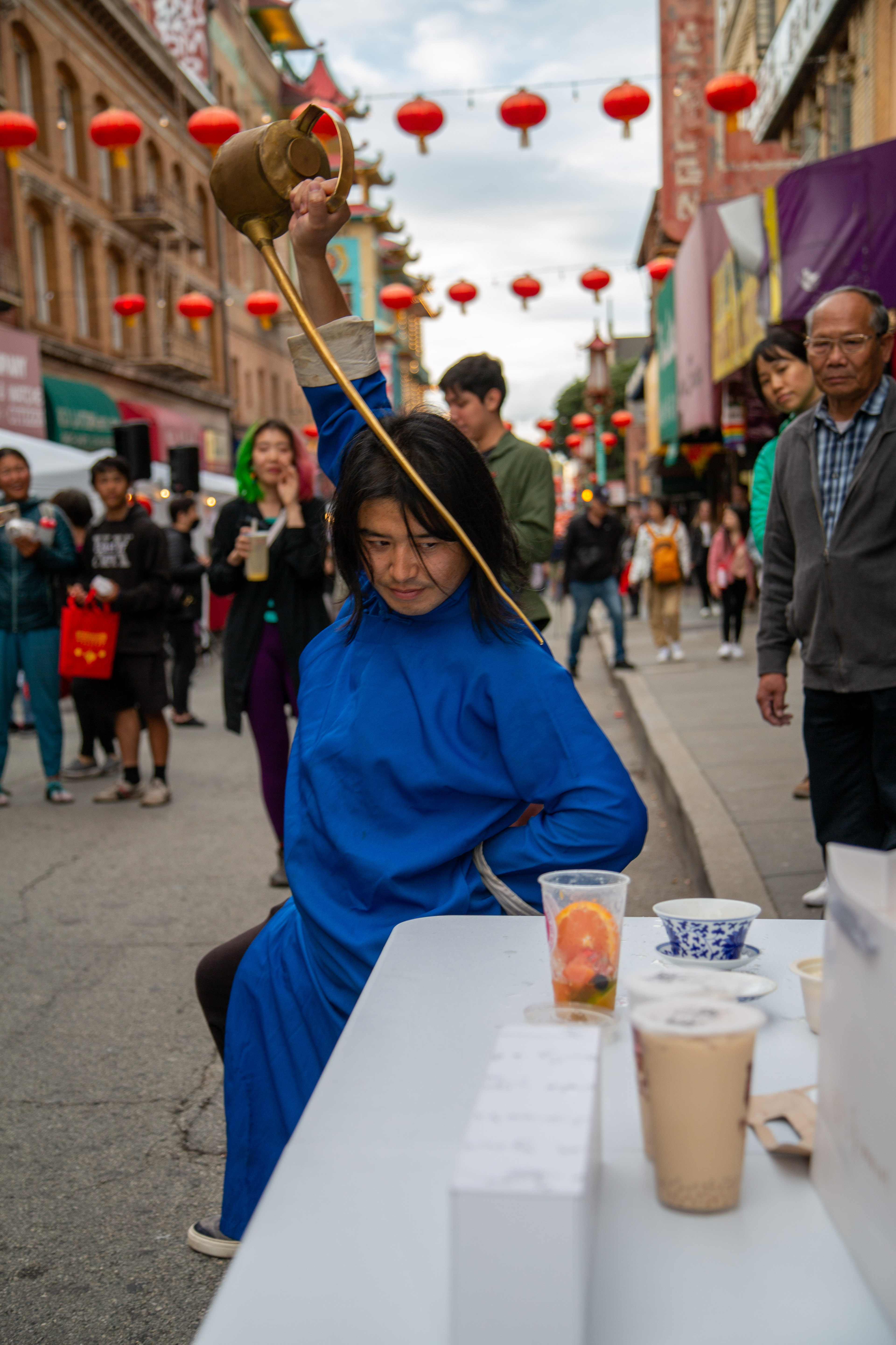 A performer with the long spout teapot pours the tea in a performance at the San Francisco Chinatown Night Market event on September 29, 2023.