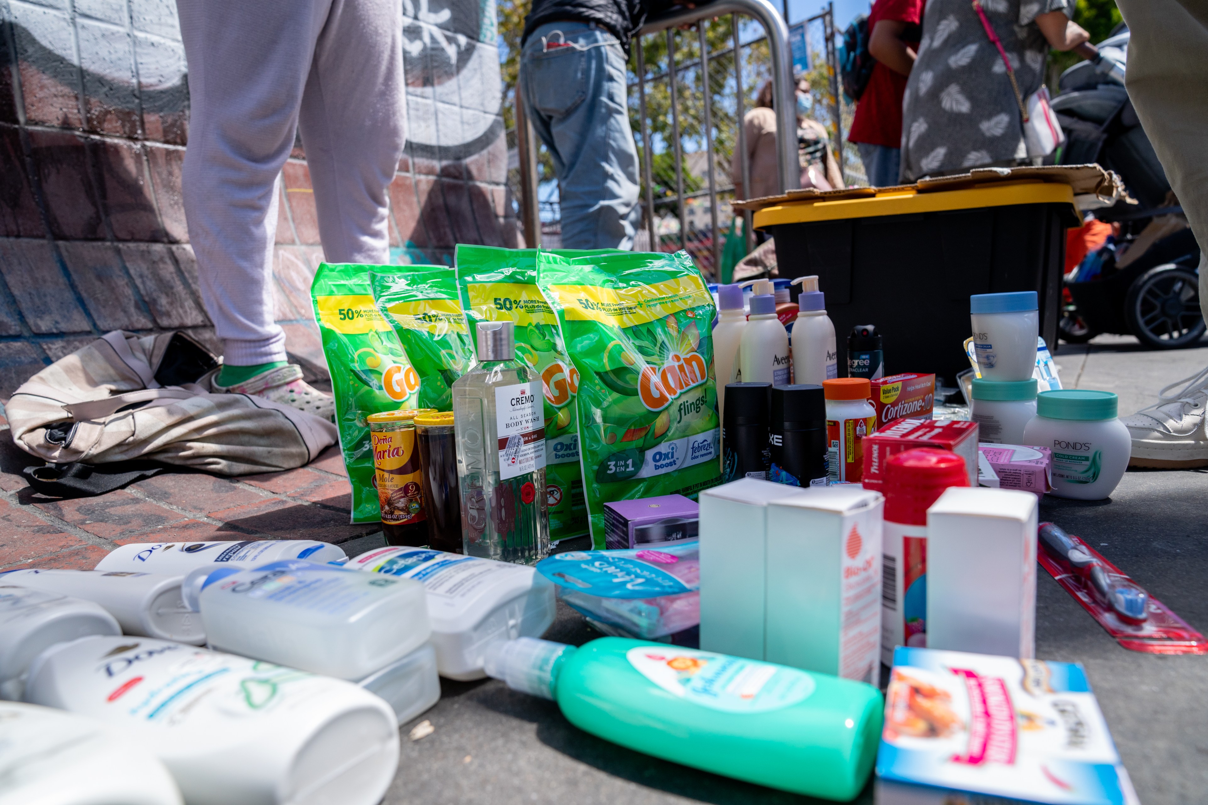 A photo of shampoos, toothpaste, laundry detergent, and other goods is spread across the concrete sidewalk on Mission Street in San Francisco.