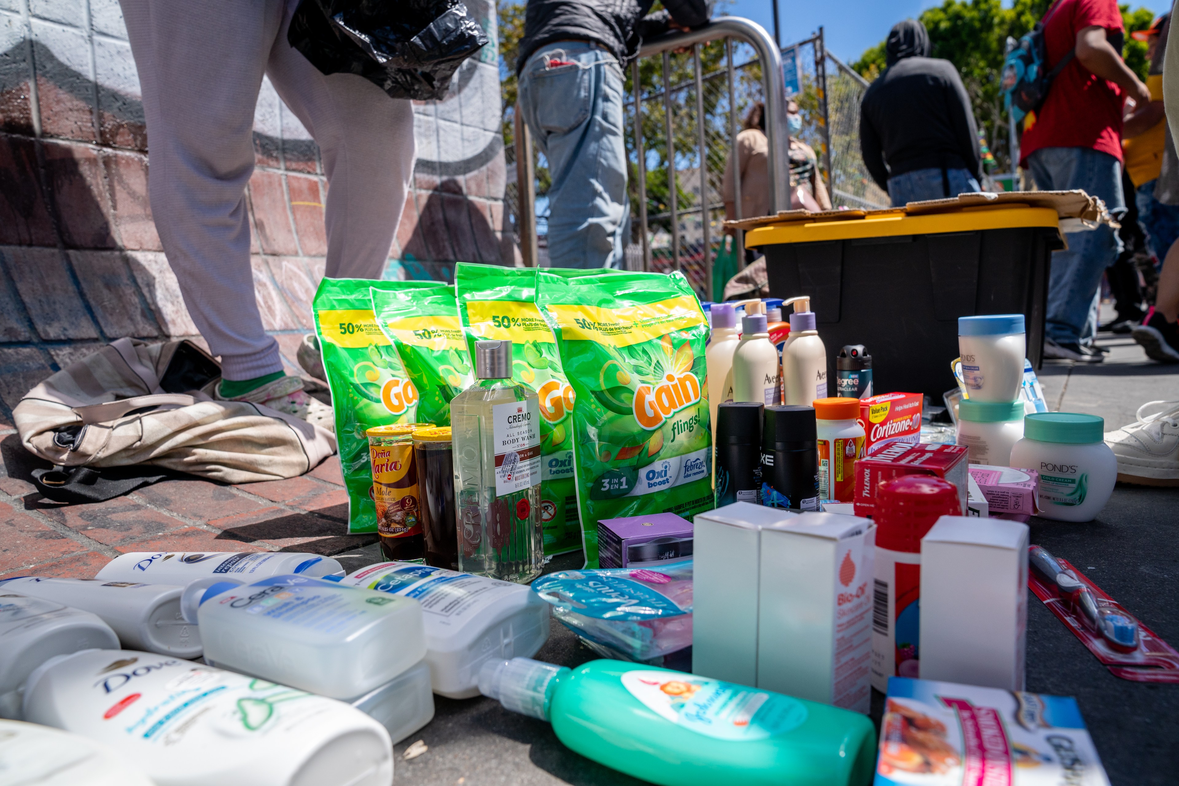 A photo of shampoos, toothpaste, laundry detergent, and other goods is spread across the concrete sidewalk on Mission Street in San Francisco.