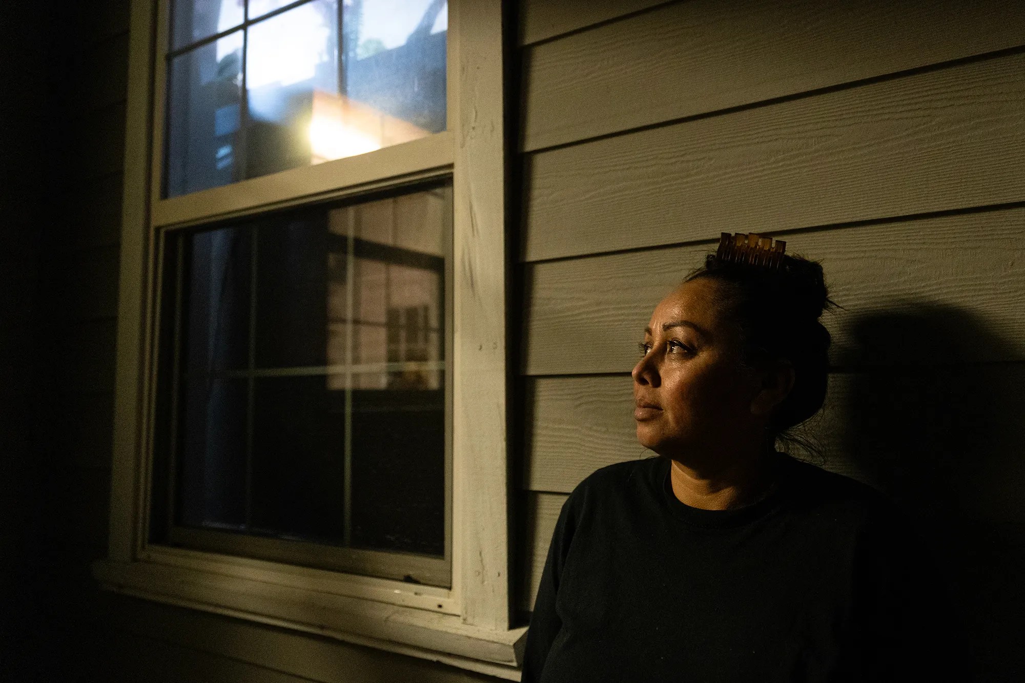Woman stands outside her home in San Leandro, California