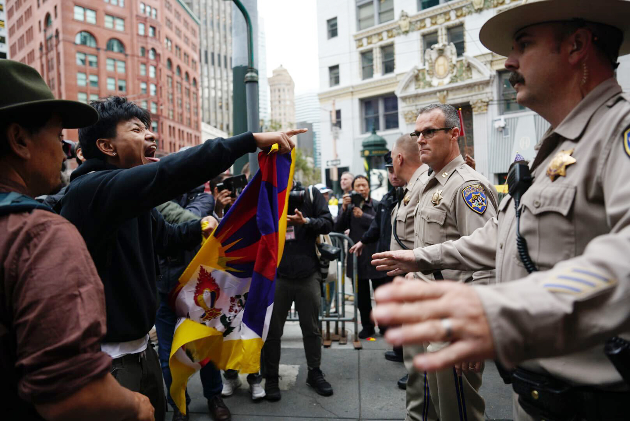 A pro-Tibetan protester screams and points in the direction of California Highways Patrol during a demonstration