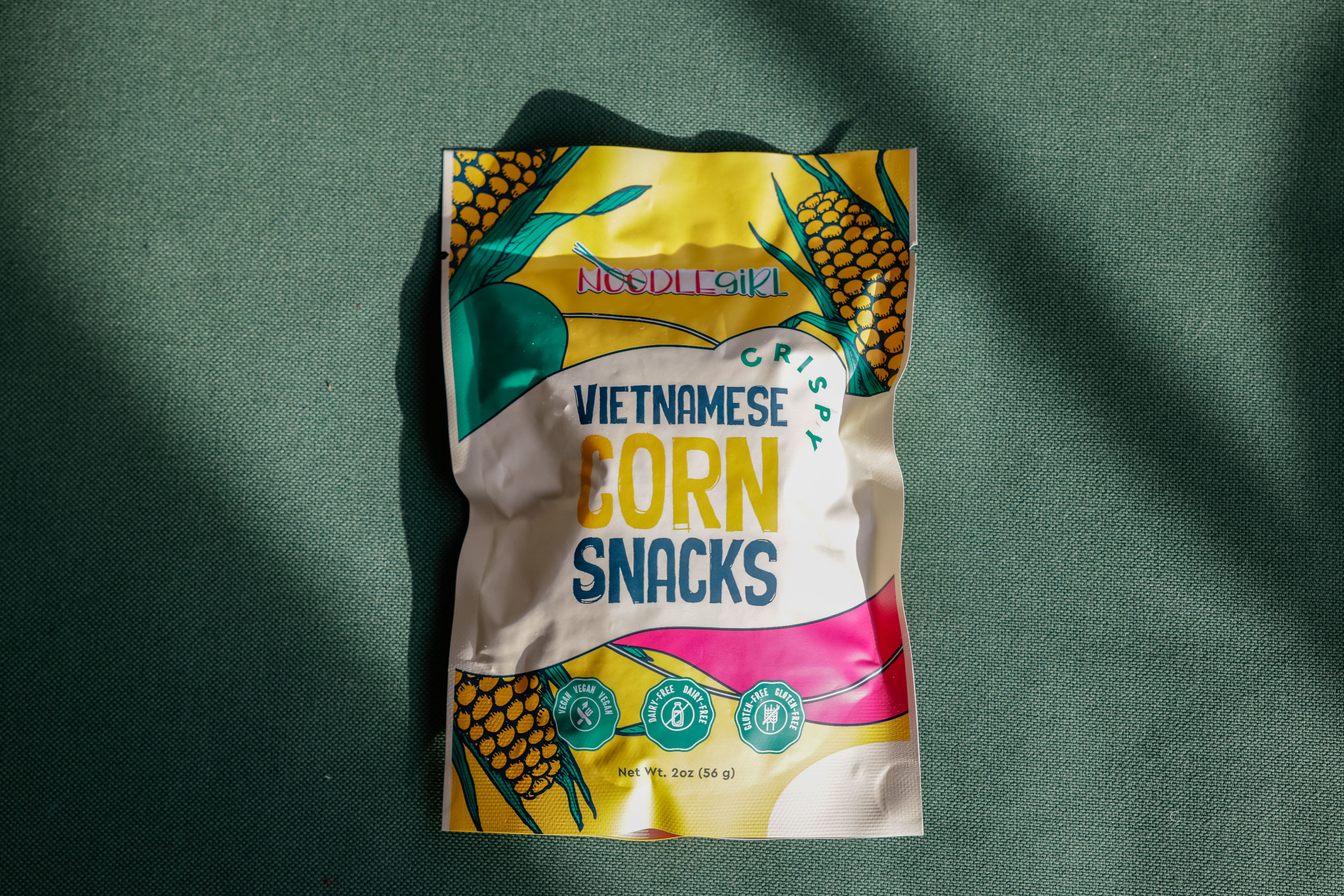 A top-down product shot of Noodle Girls Vietnamese Corn Snacks.