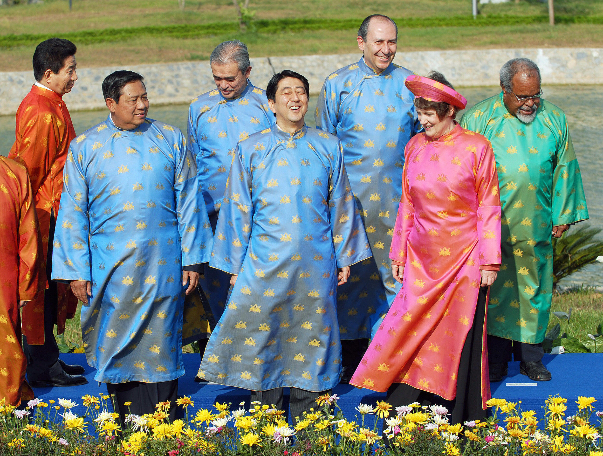 World leaders wearing colorful traditional Vietnamese attire pose for a group photo.