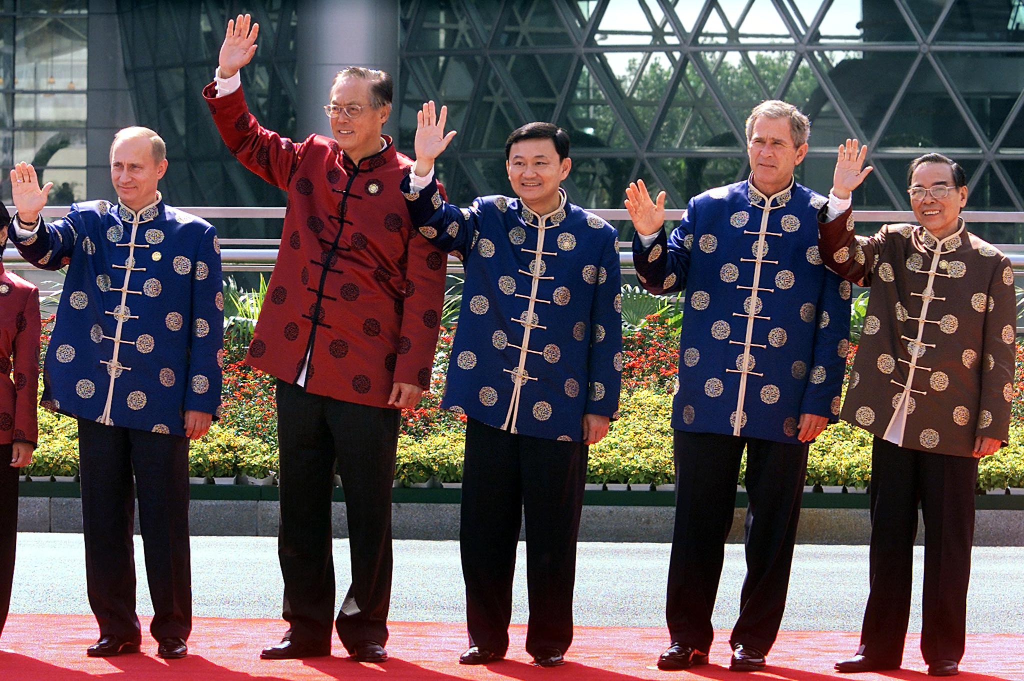 World leaders, dressed in traditional Chinese attire, pose for a photo taken by the press.