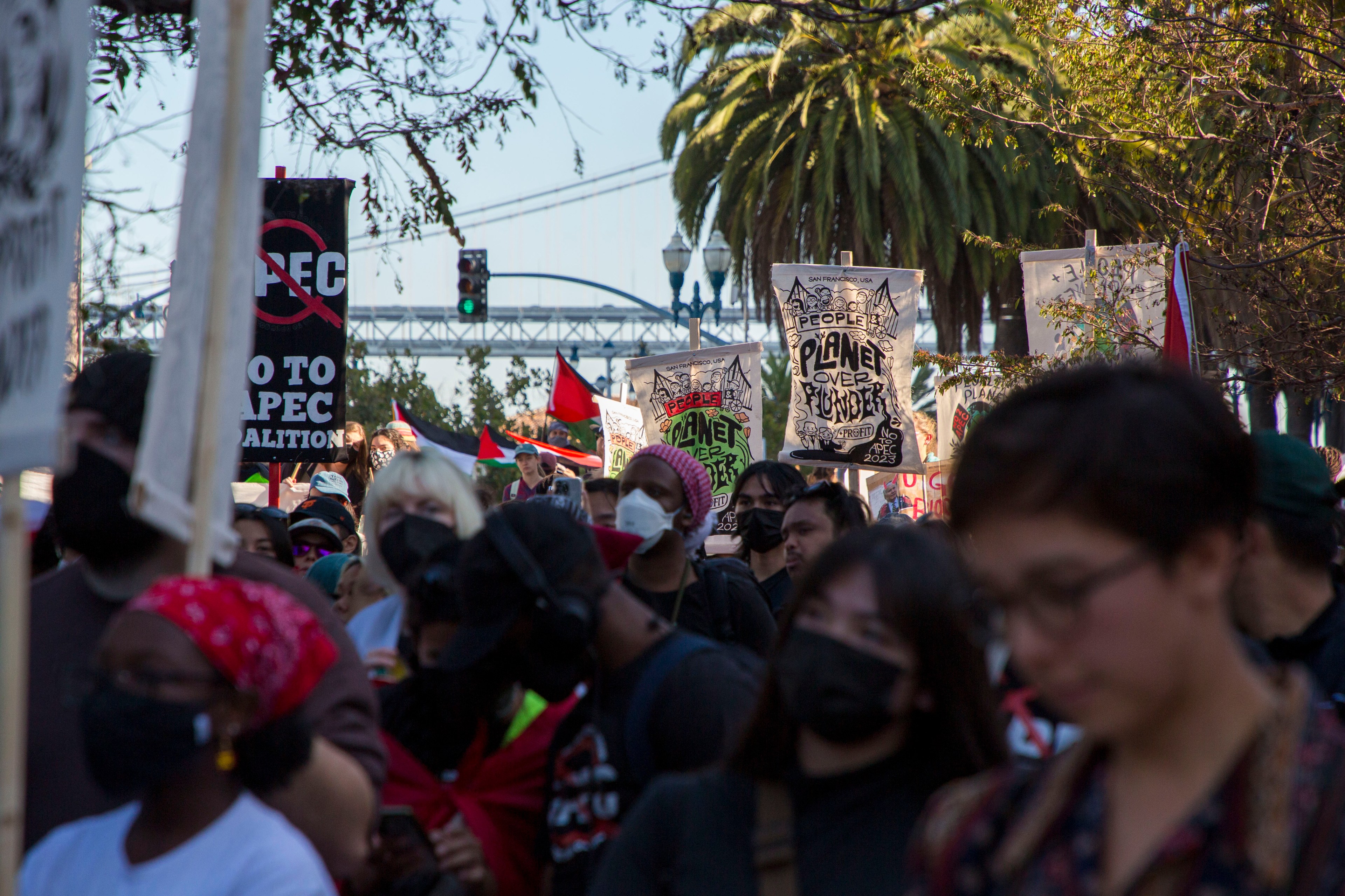 Thousands of people marched through San Francisco holding signs that read &quot;Planet over Plunder&quot; and &quot;No 2 APEC&quot;.