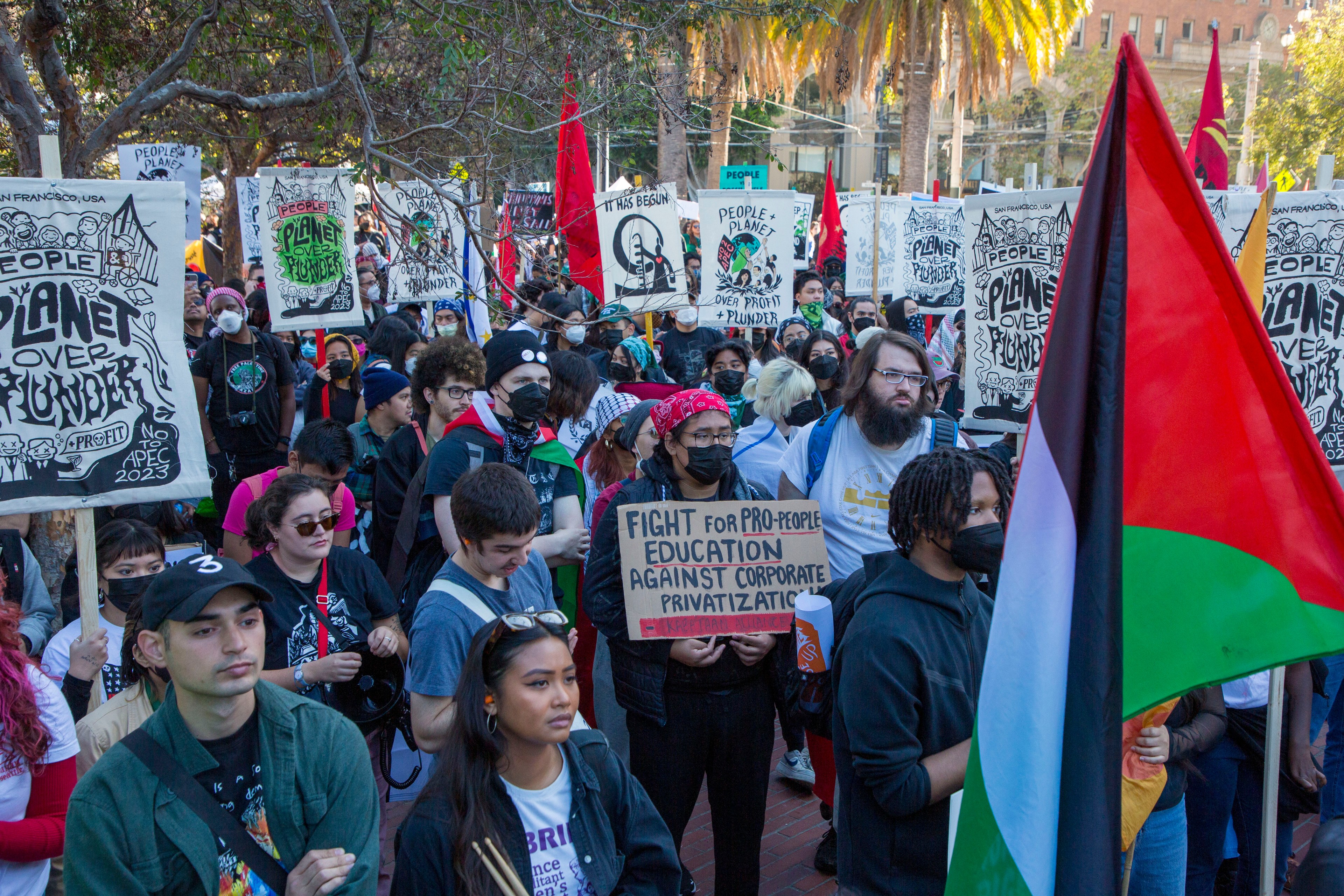 Thousands of people marched through San Francisco holding signs that read &quot;Planet over Plunder&quot; and &quot;No 2 APEC&quot;.