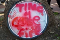 &quot;Time 4 Cease Fire&quot; sprayed on a clock with red paint.