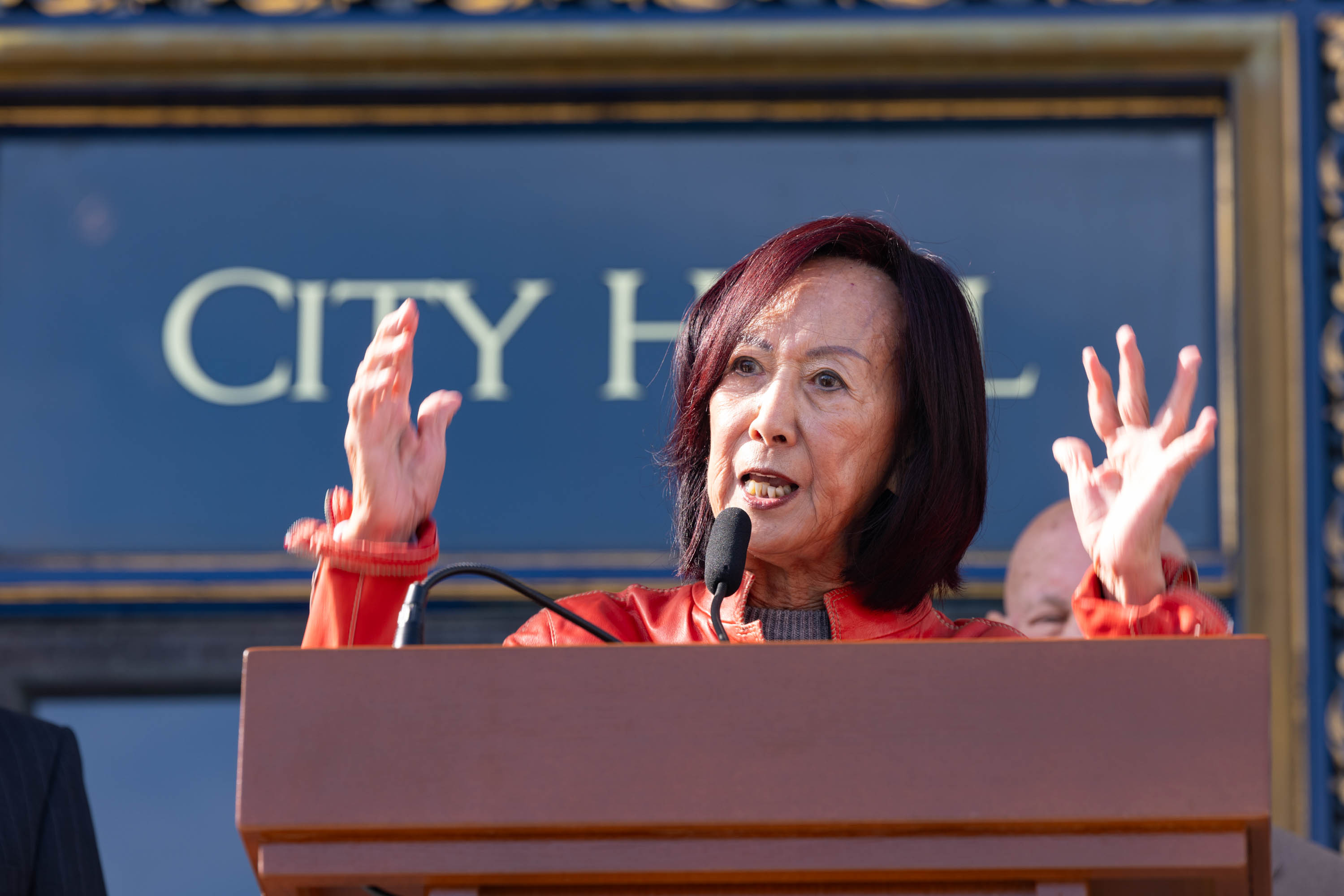 Former San Francisco County Superior Court judge Lillian Sing gestures with her hands up at press conference.