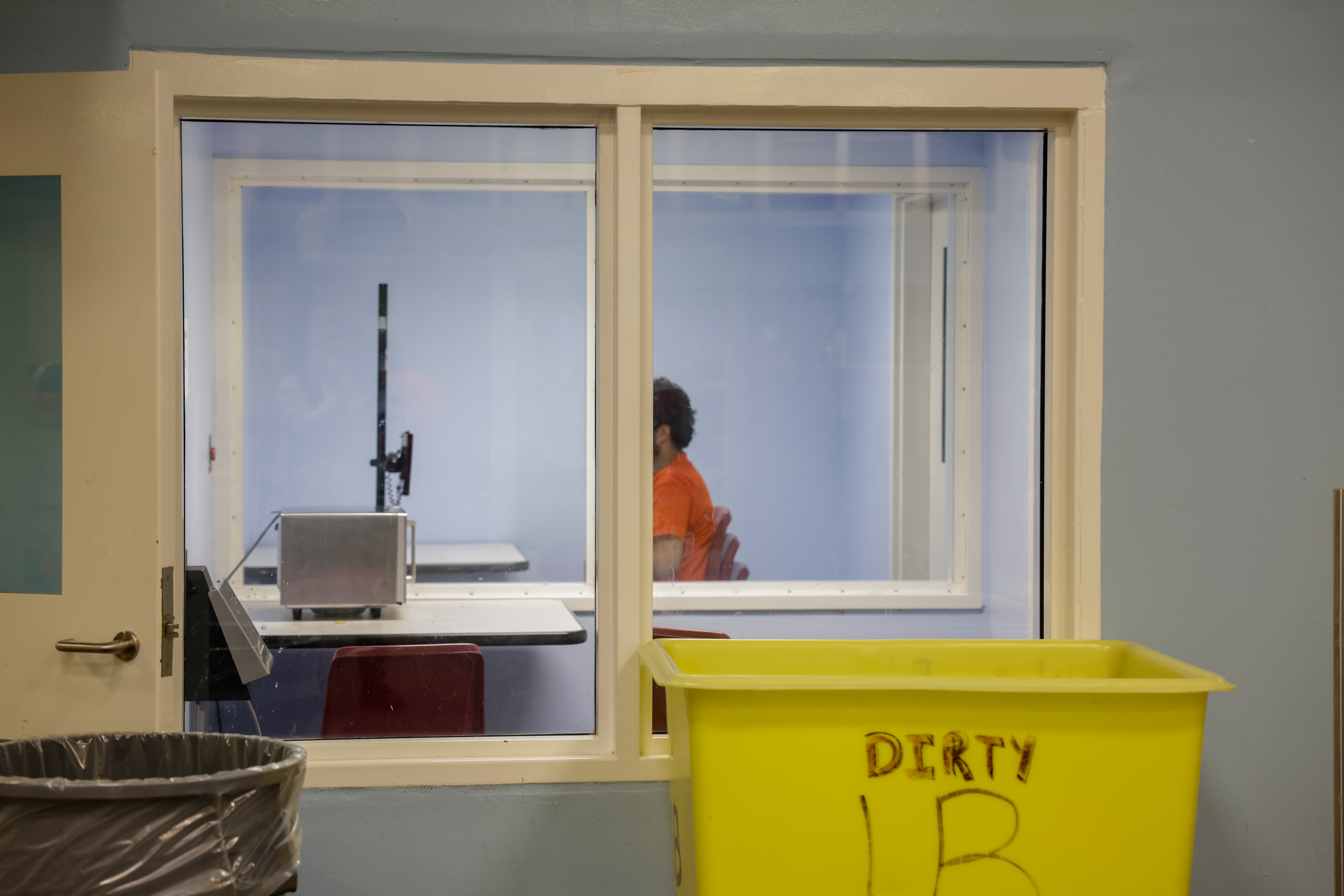 An inmate makes a Zoom call inside a room reserved for conversations with social workers and attorneys.