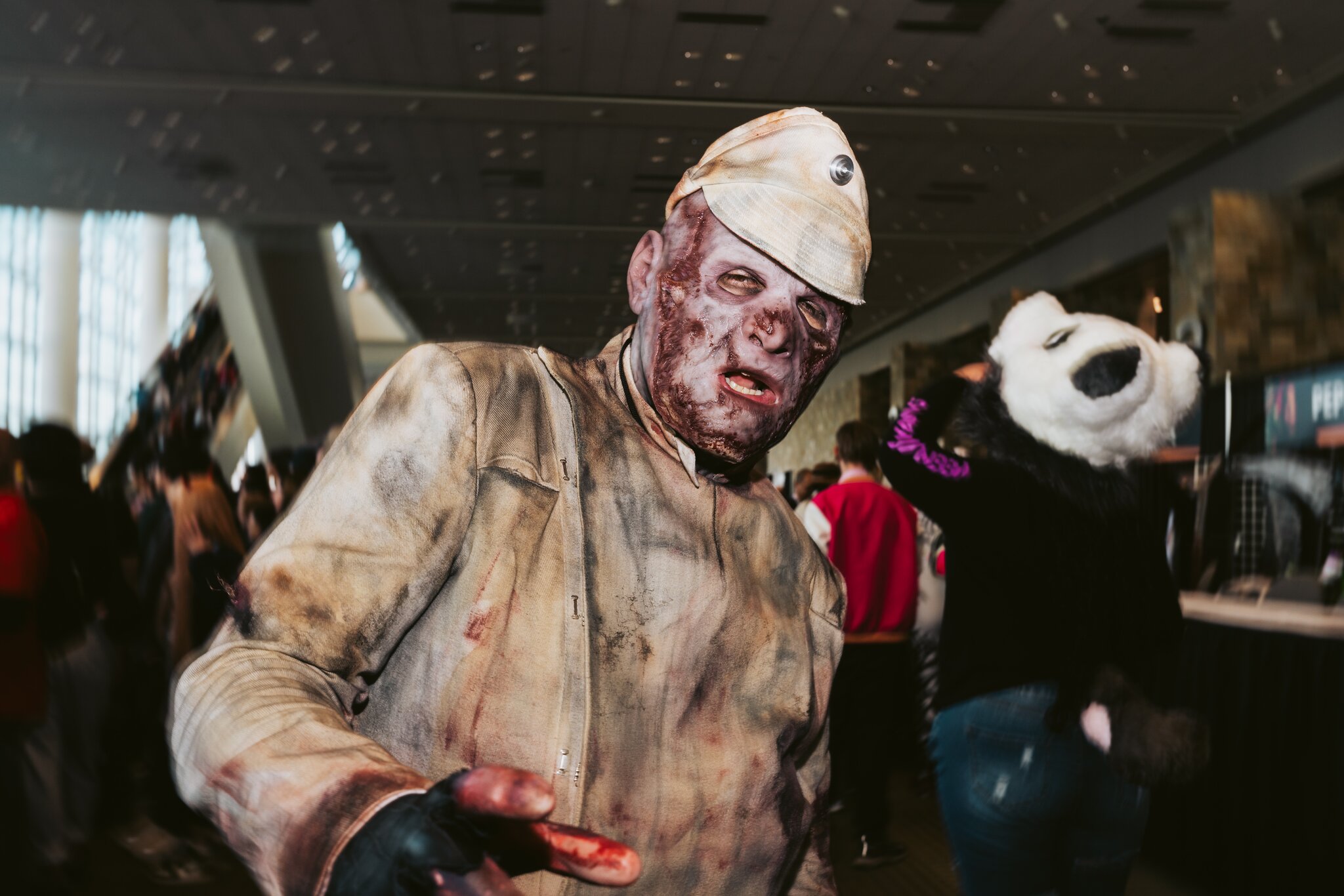A man in a dirty costume resembles a zombie.