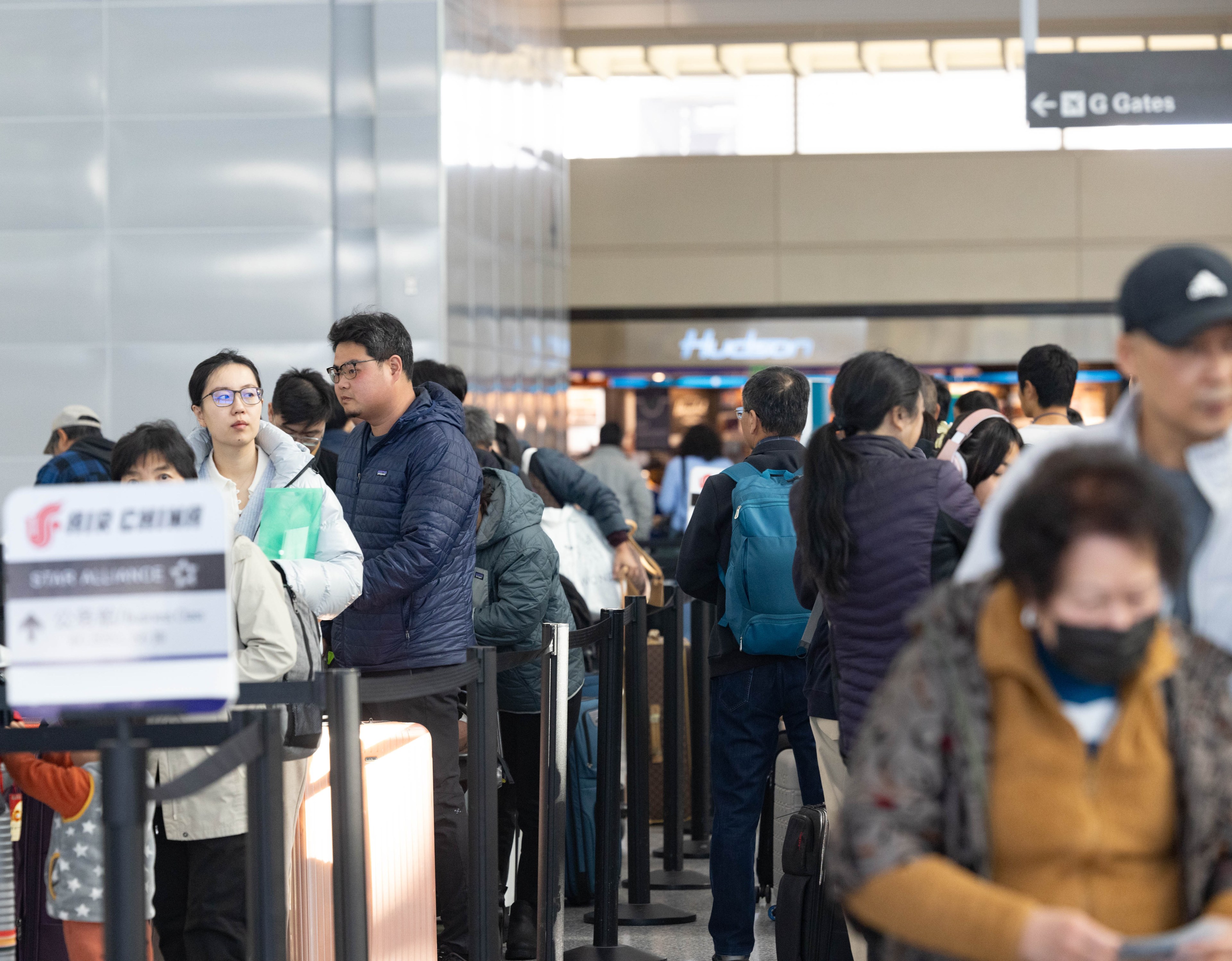 Travelers wait to get checked in at the San Francisco International Airport Air China gate on Wednesday, Nov. 22, 2023. Many are leaving town before the Thanksgiving holiday on Thursday.