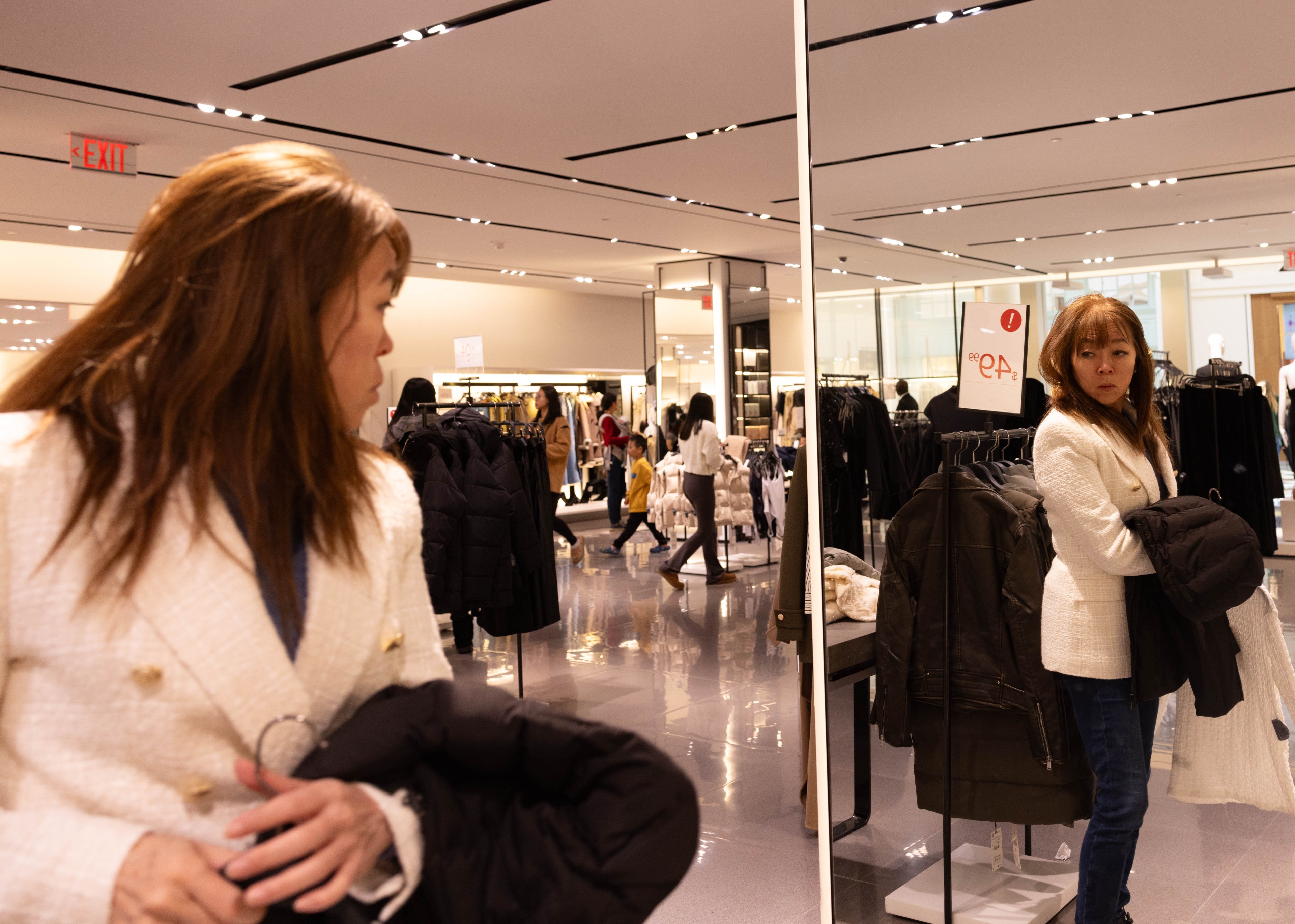 A shopper looks in a mirror inside Stonestown Galleria's Zara.