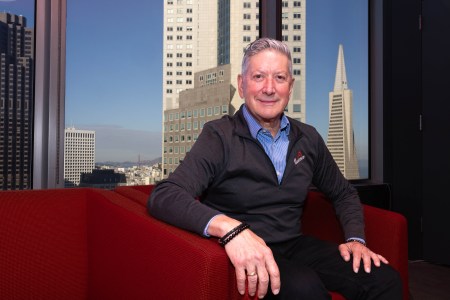 Joe D’ Alessandro sits in an office looking over the city of San Francisco.