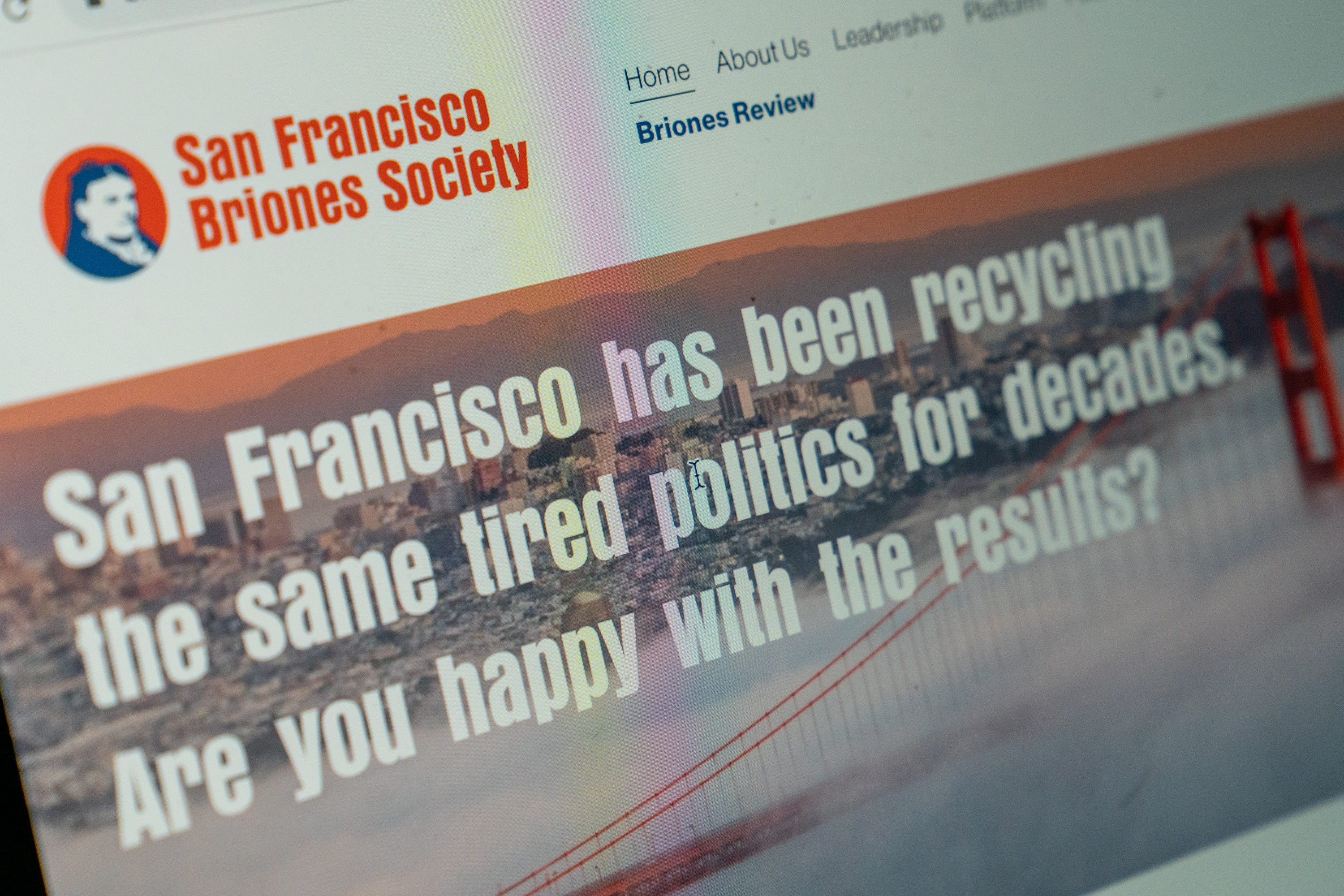 A laptop with the website for San Francisco Brones Society that reads &quot;San Francsico has been recycling the same tired politics for decades. Are. you happy with the Results?
