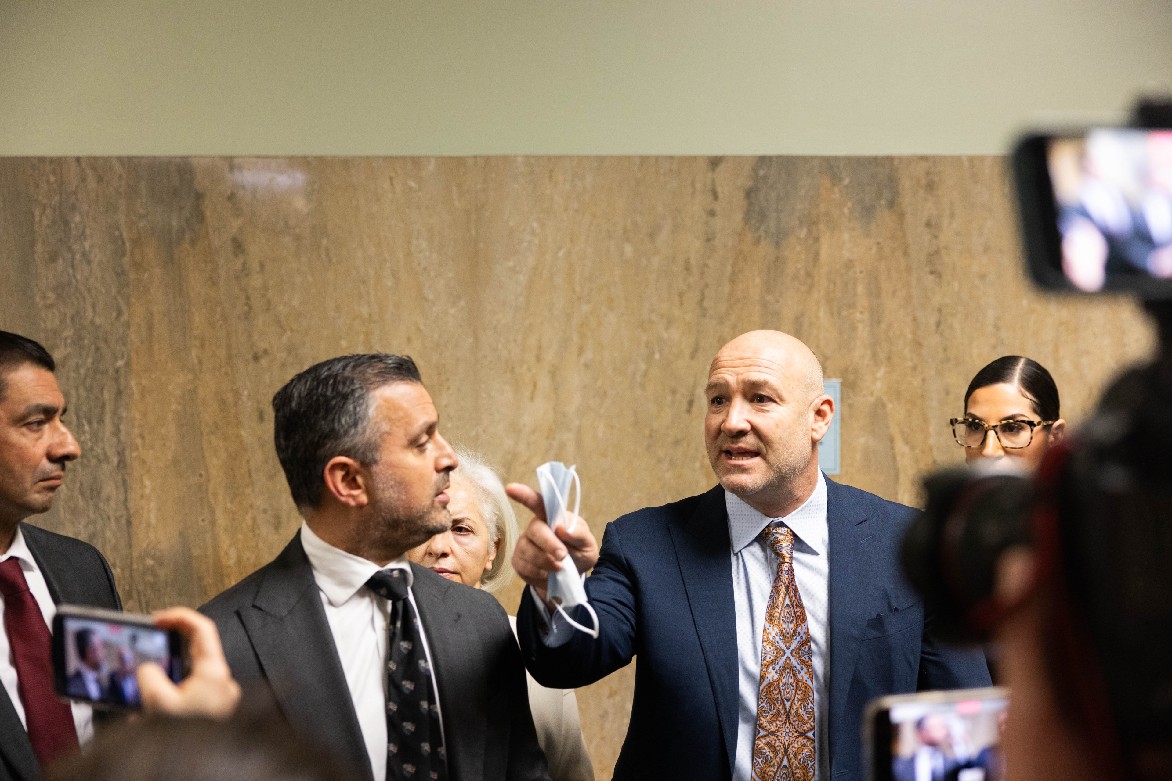 articles nima A press conference with lawyers speaking to the media.