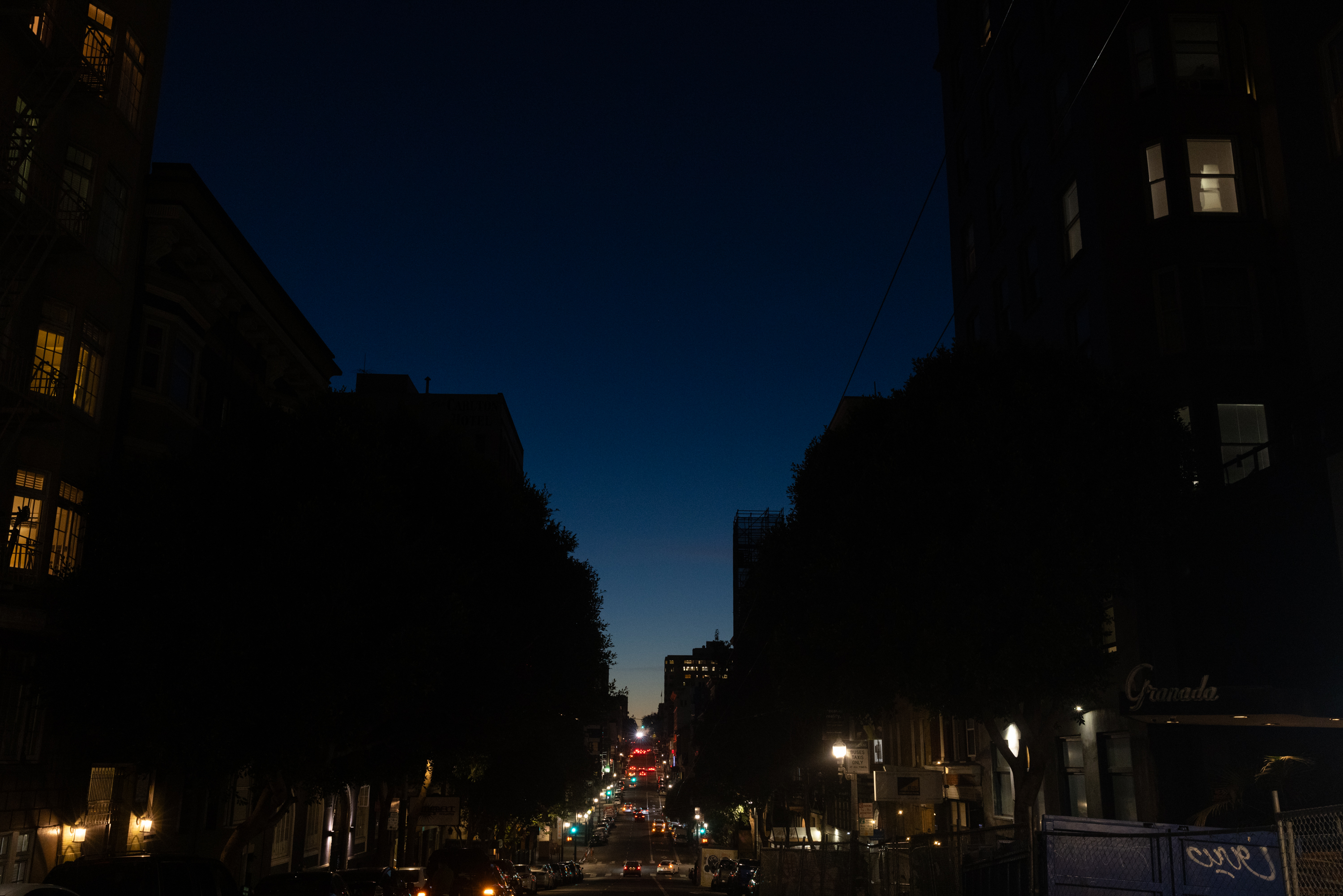 As night sets in San Francisco, the street of Sutter is illuminated by city and apartment lights. 