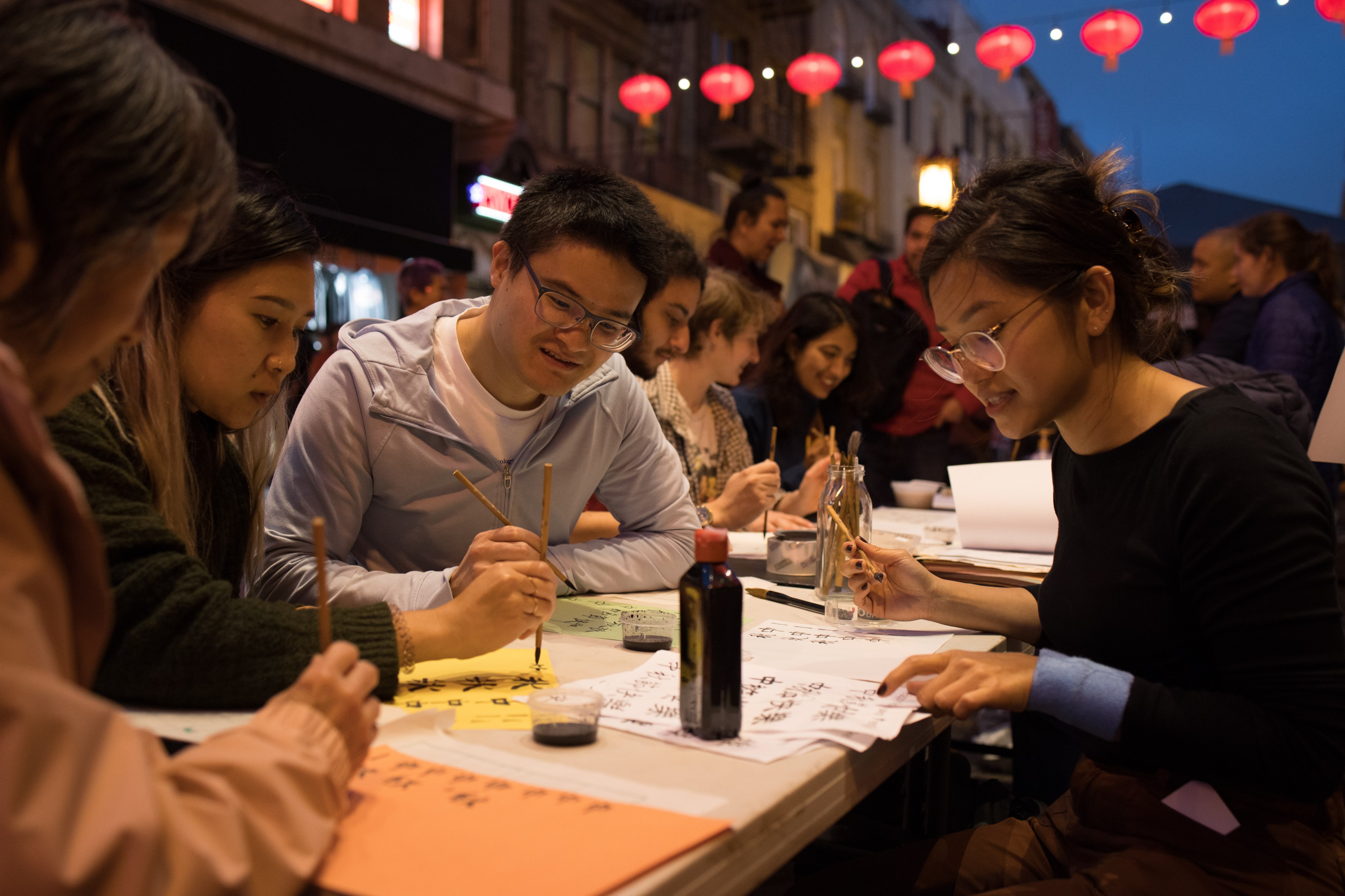 Visitors at Chinatown Night Market event learn about Chinese calligraphy on September 29, 2023.