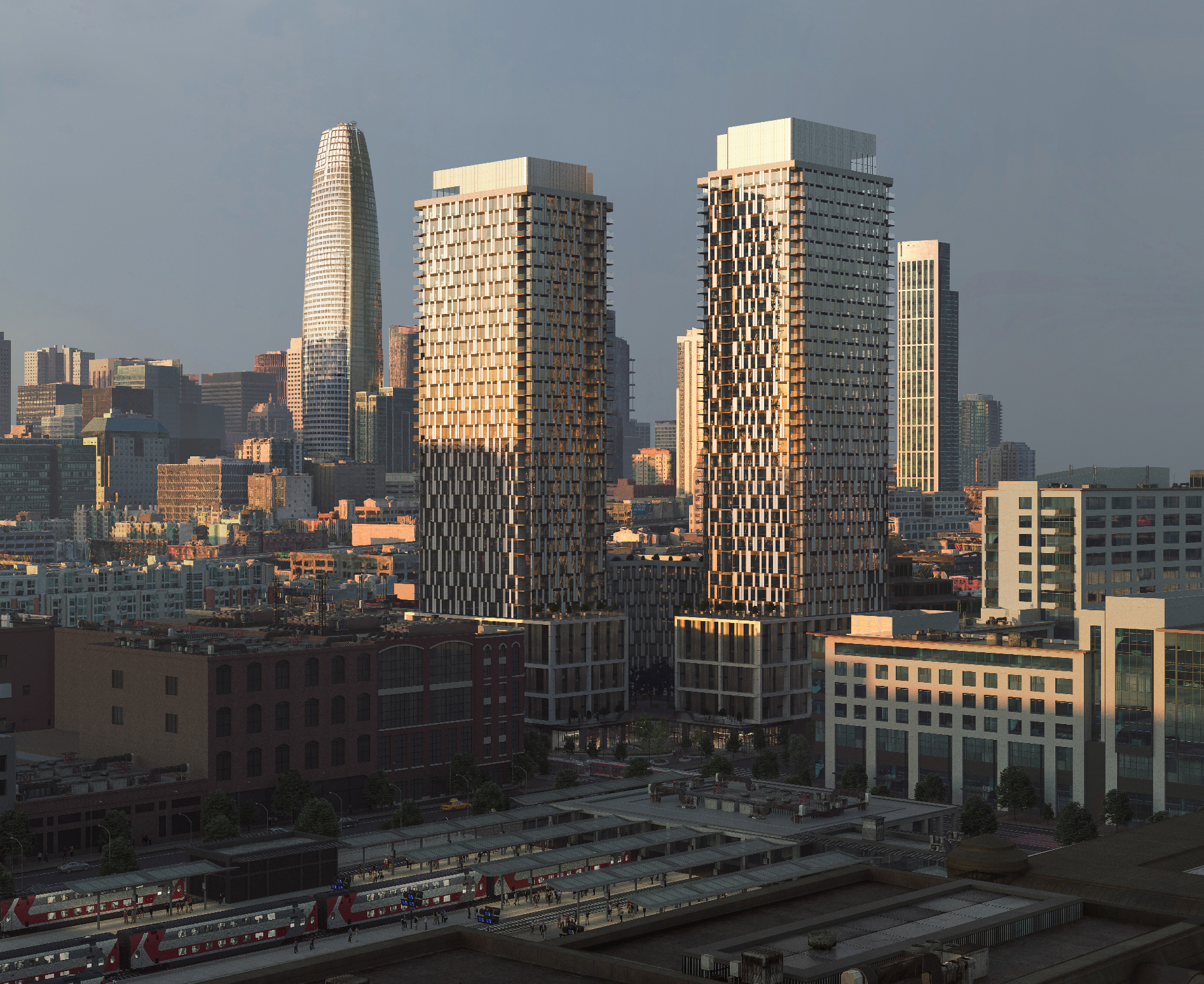 Two tall buildings rise from a shared podium base against a skyline with other tall buildings nearby and a train yard in the near foreground.