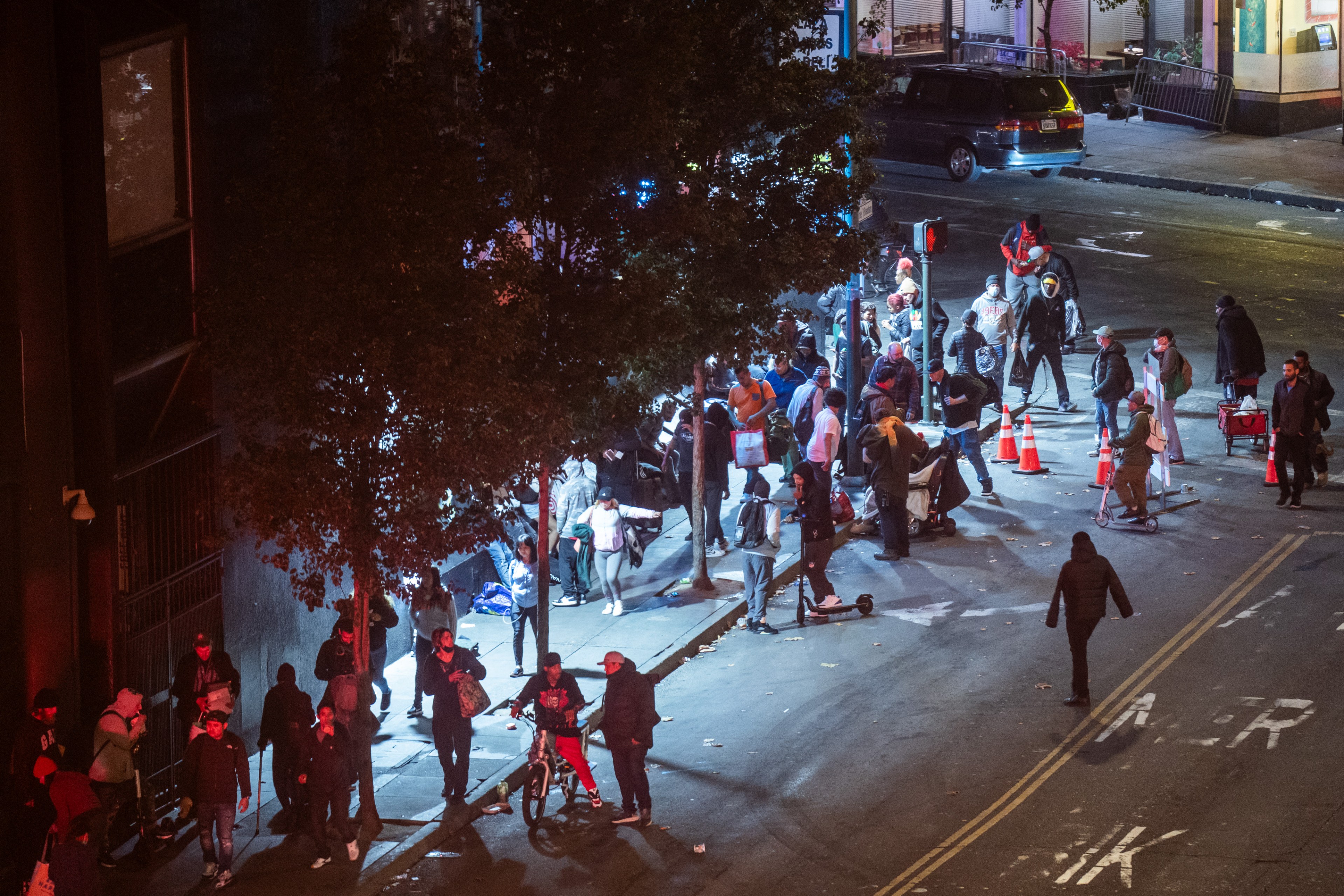 People congregate near the intersection of 7th and Market in downtown San Francisco on Oct. 16, 2023.