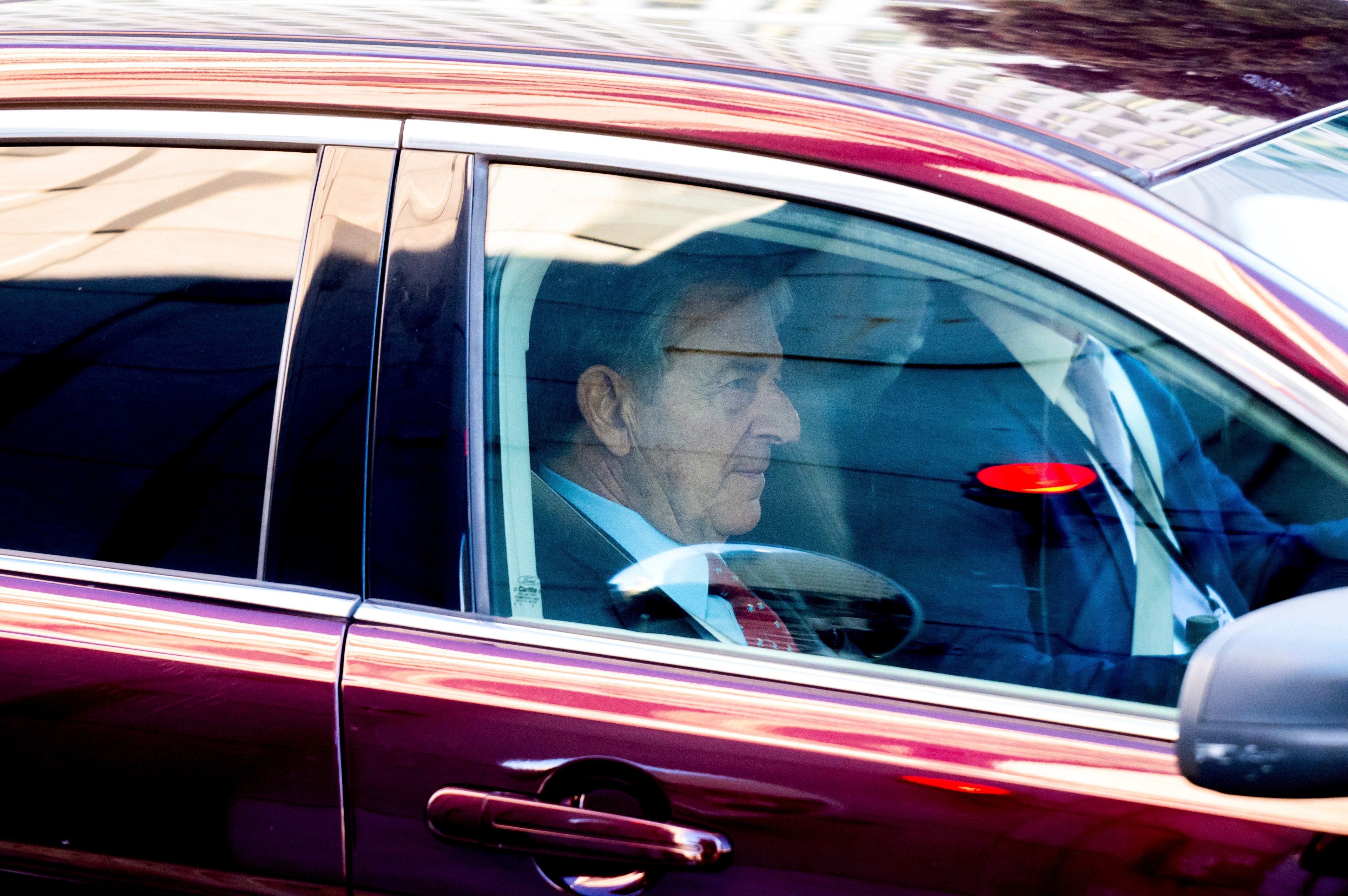 Paul Pelosi in the passenger seat of a vehicle.