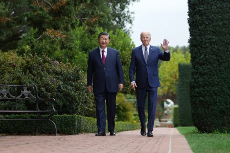 articles nima Two men in suits, Xi Jinping and Joe Biden, walk through a garden
