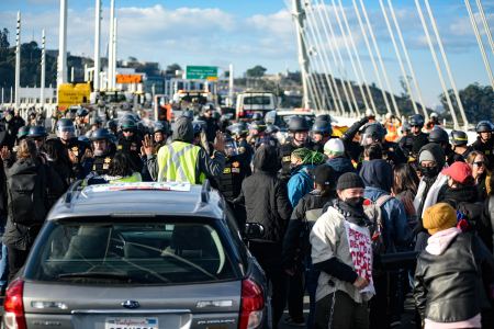 Demonstrators calling for a ceasefire in Gaza block traffic during a protest on the Bay Bridge on Nov. 16, 2023.