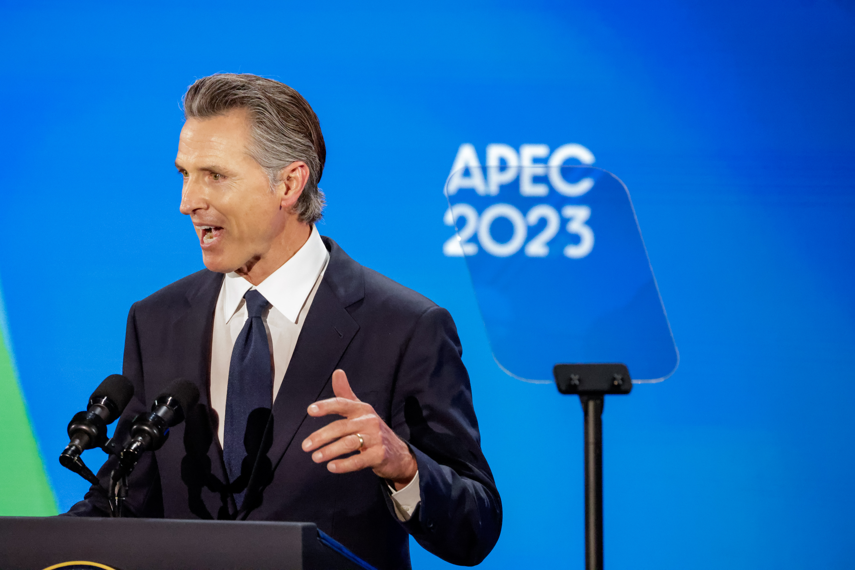 Gov. Gavin Newson gives a speech at a podium during President Joe Biden welcome party during APEC week. 