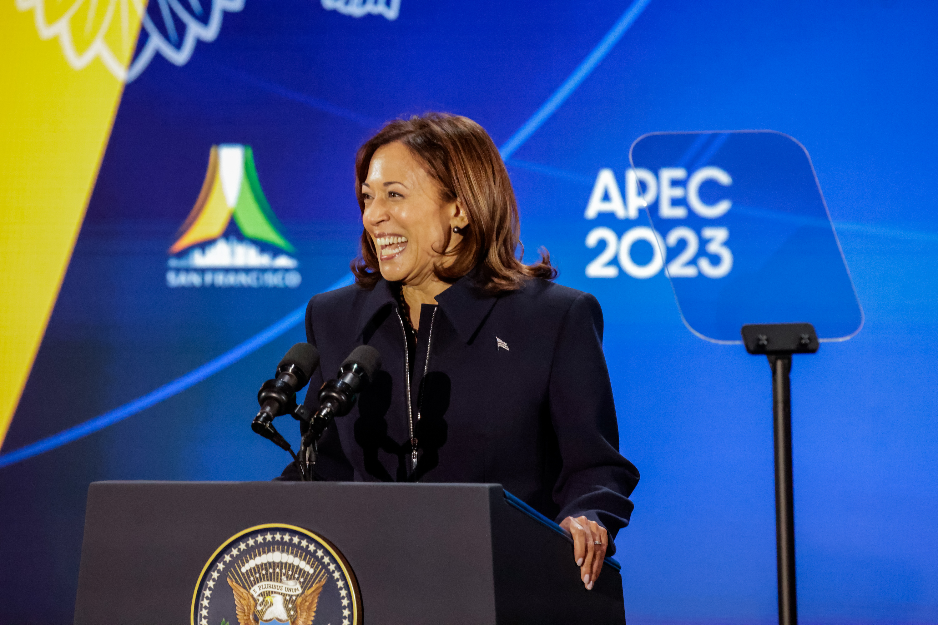 Vice President Kamala Harris delivers a speech at a podium during APEC week for President Joe Biden's welcome party. 