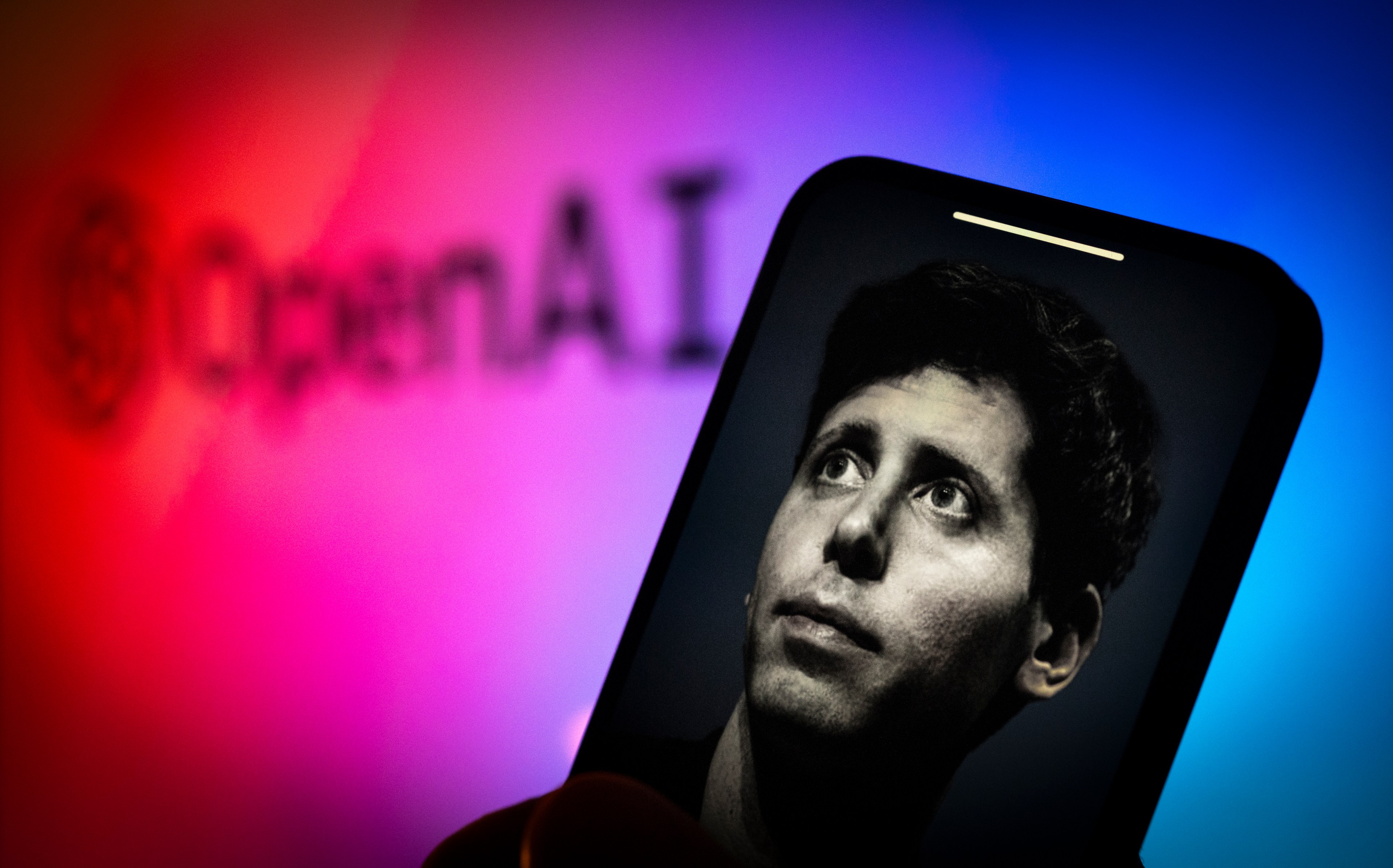 A photo illustration of former OpenAI CEO Sam Altman on a mobile device