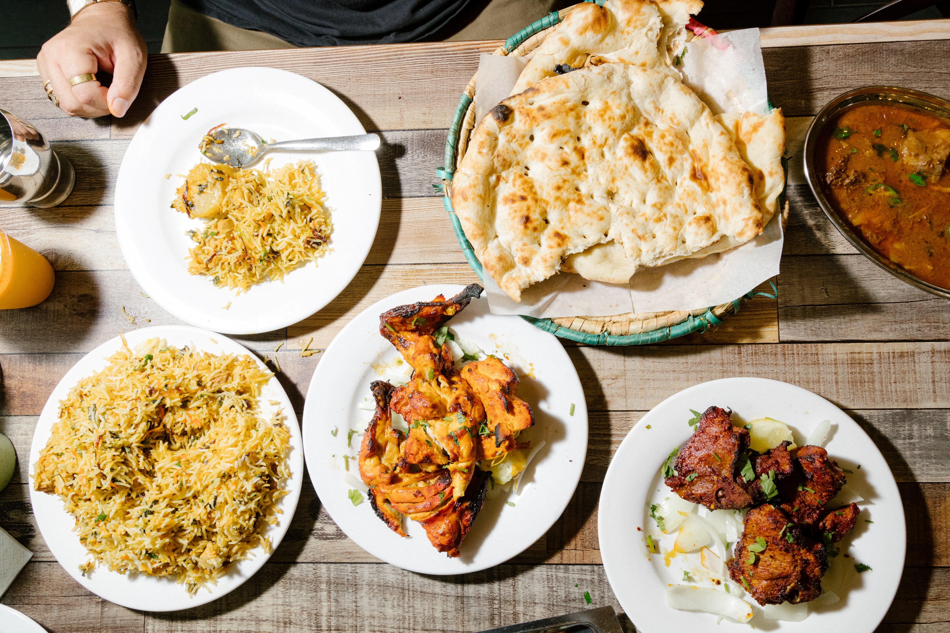 Chicken, seekh, chicken thigh, and lamb chop kabobs with naan and a mango lassi at Pakwan restaurant/
