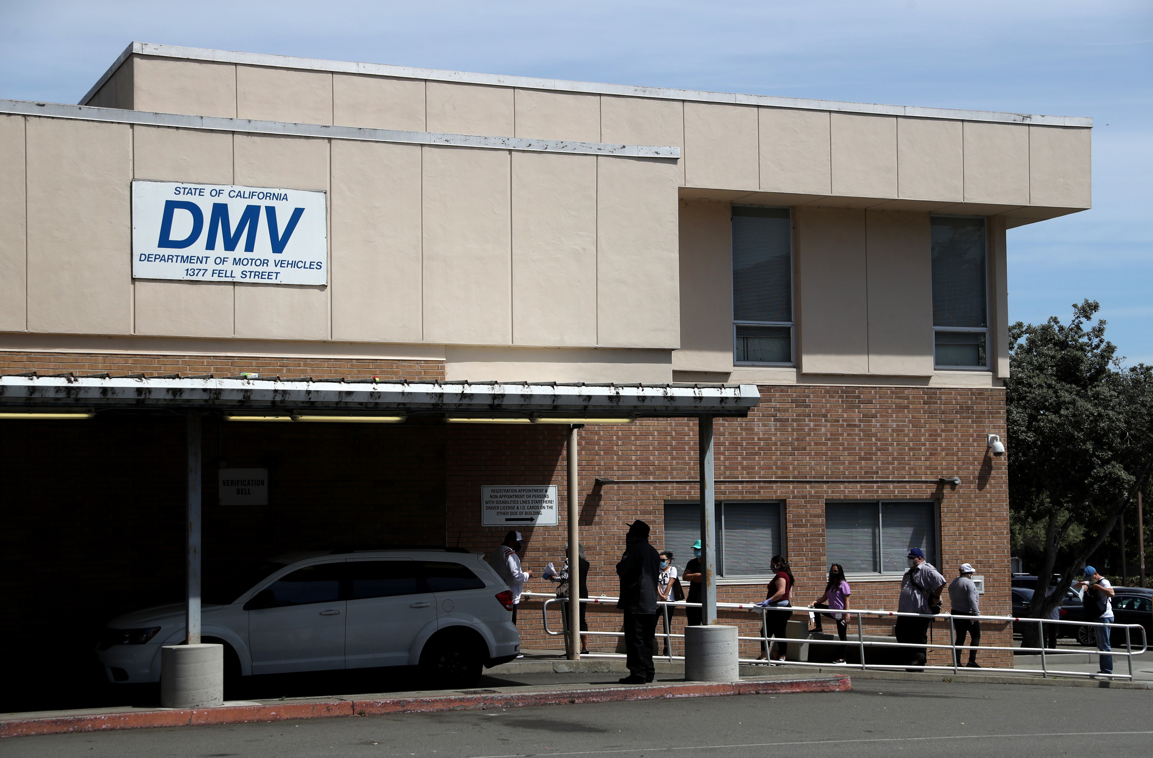 People waiting in line outside a DMV in San Francisco