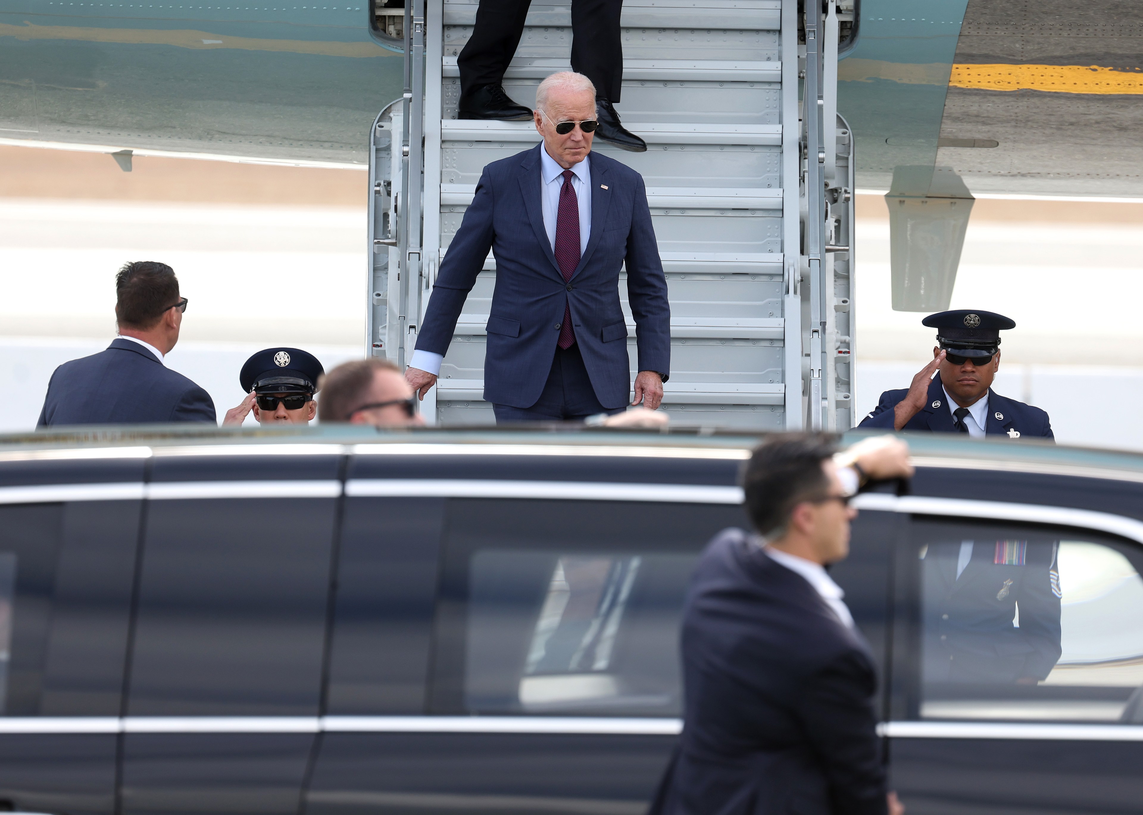 U.S. President Joe Biden walks down the stairs from Air Force One after arriving at San Francisco International Airport.