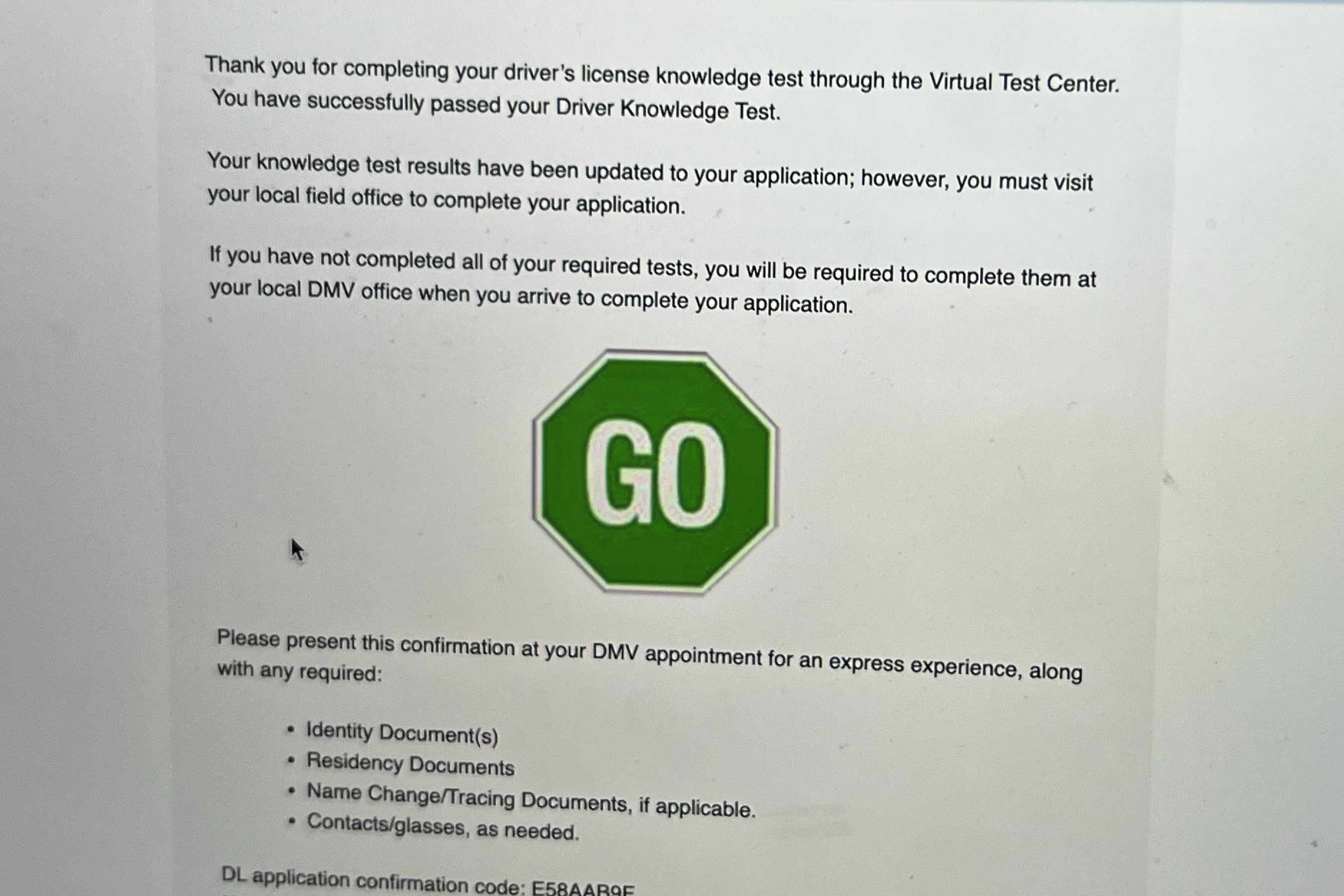 A screen on a MacBook shows that a person has passed the California driving test.