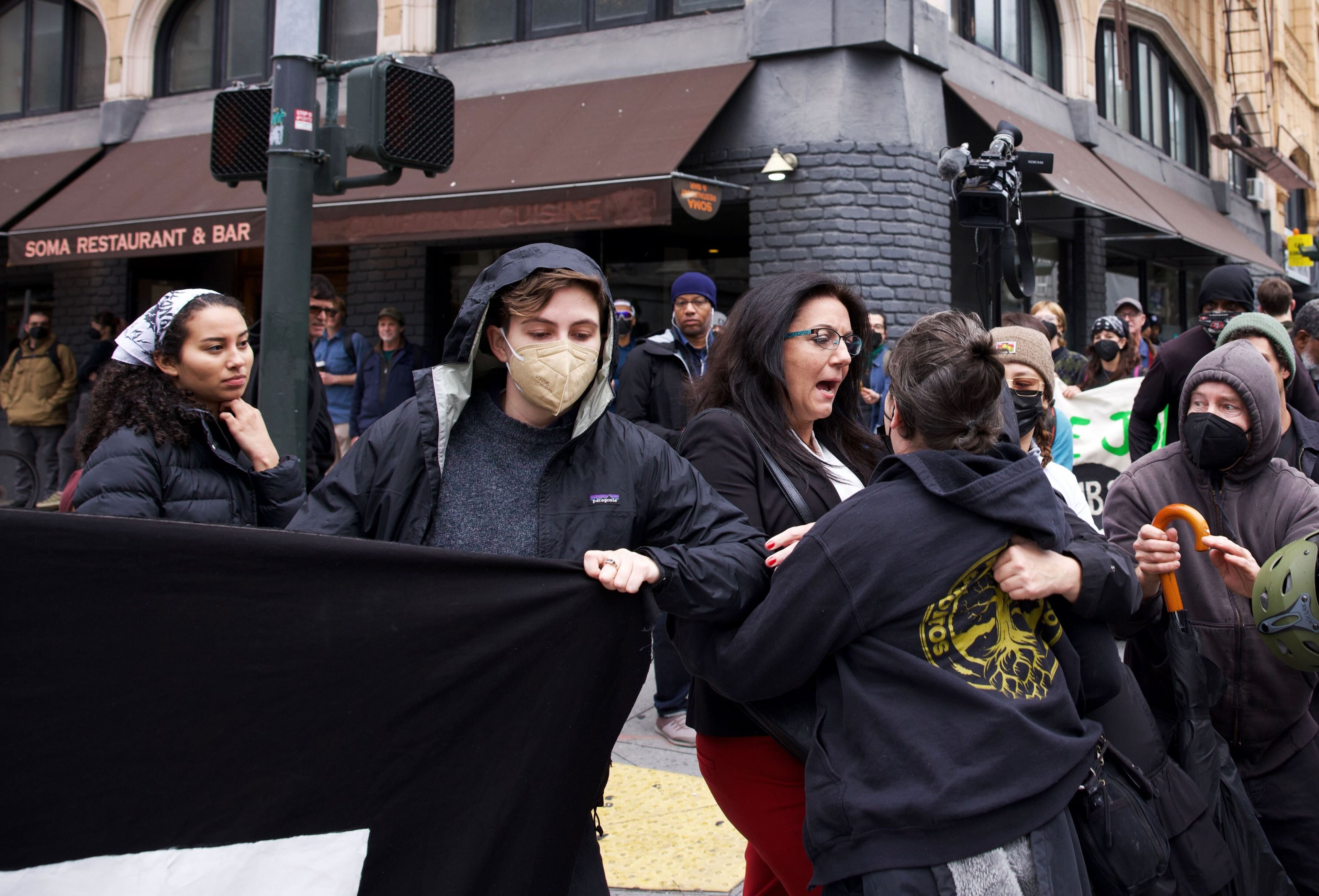 Protestors block an APEC participant from entering the area.