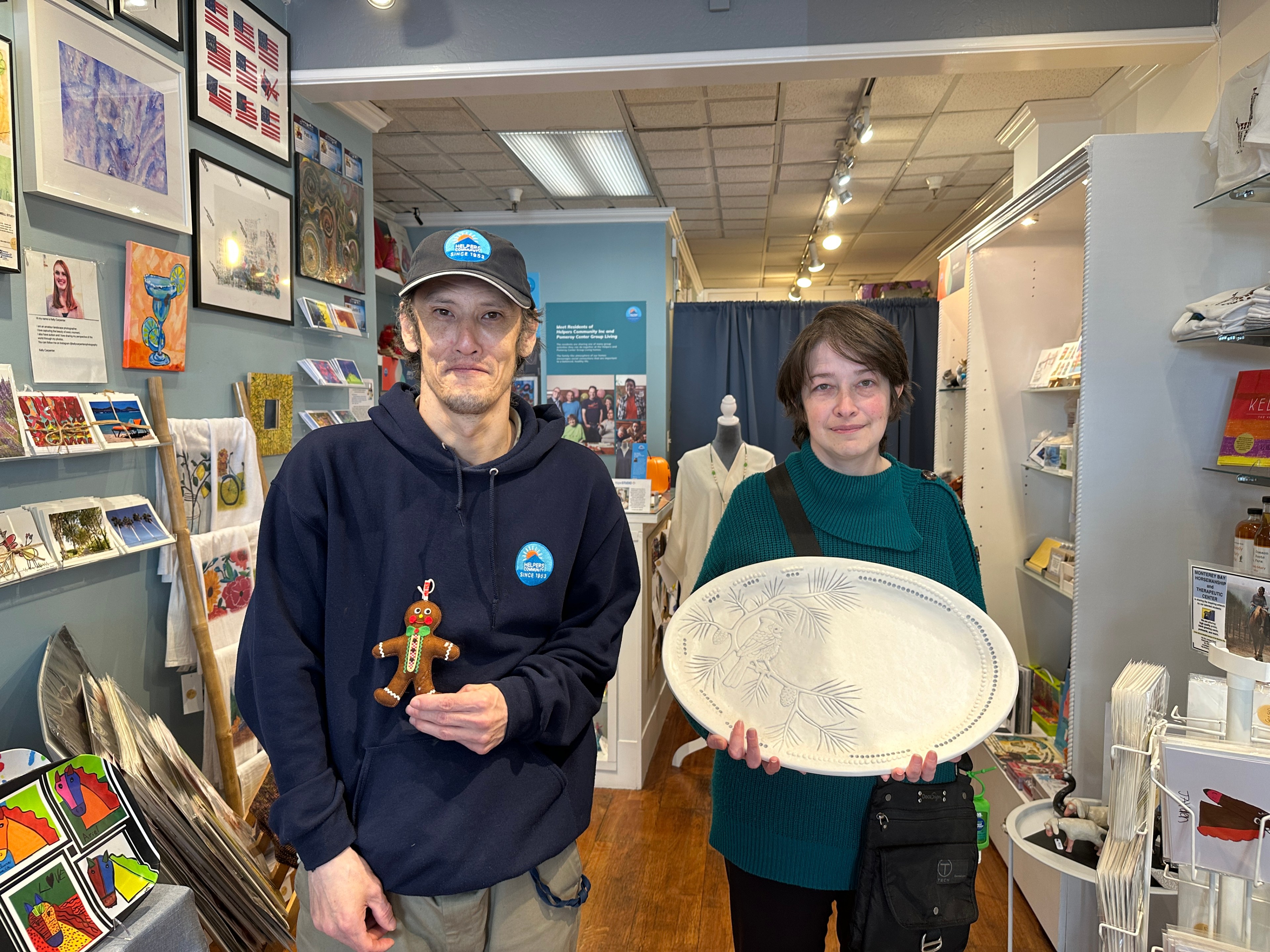 A man and woman stand in a boutique shop filled with art and items on Union Street in San Francisco, California. 