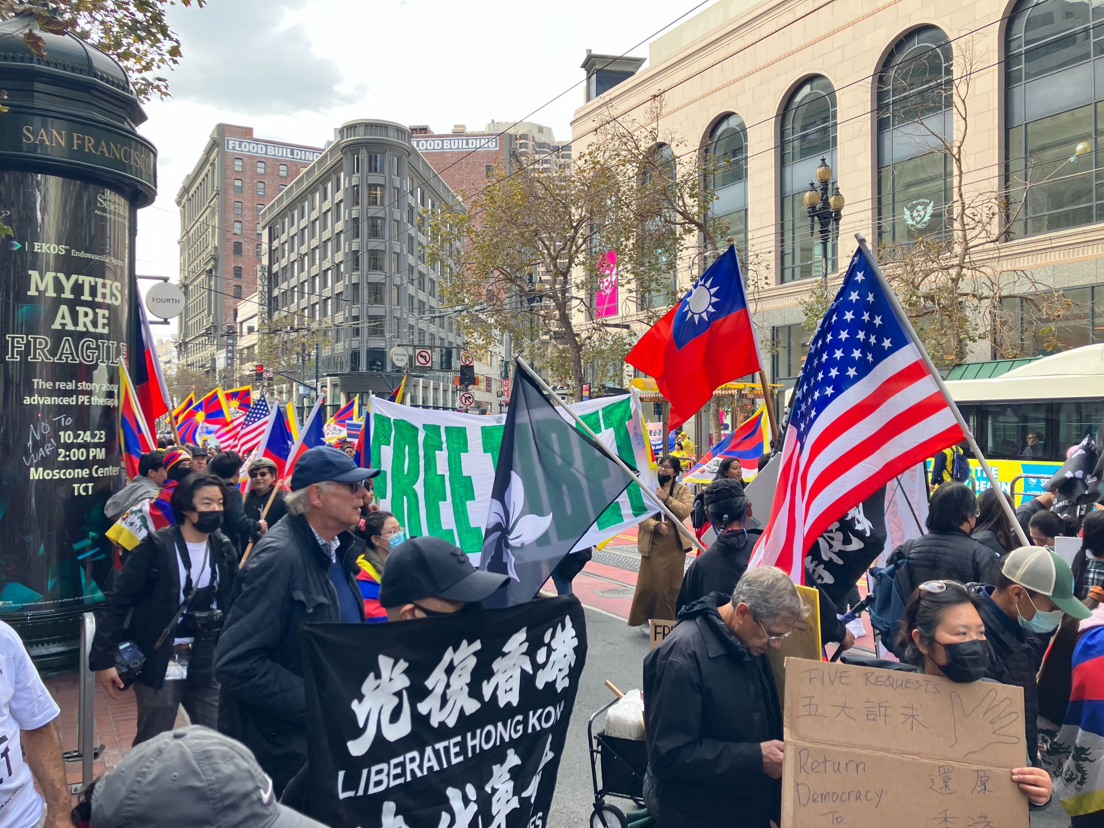 Protesters wave U.S. and Hong Kong flags and carry banners saying &quot;Liberate Hong Kong&quot; and &quot;Free Tibet.&quot;