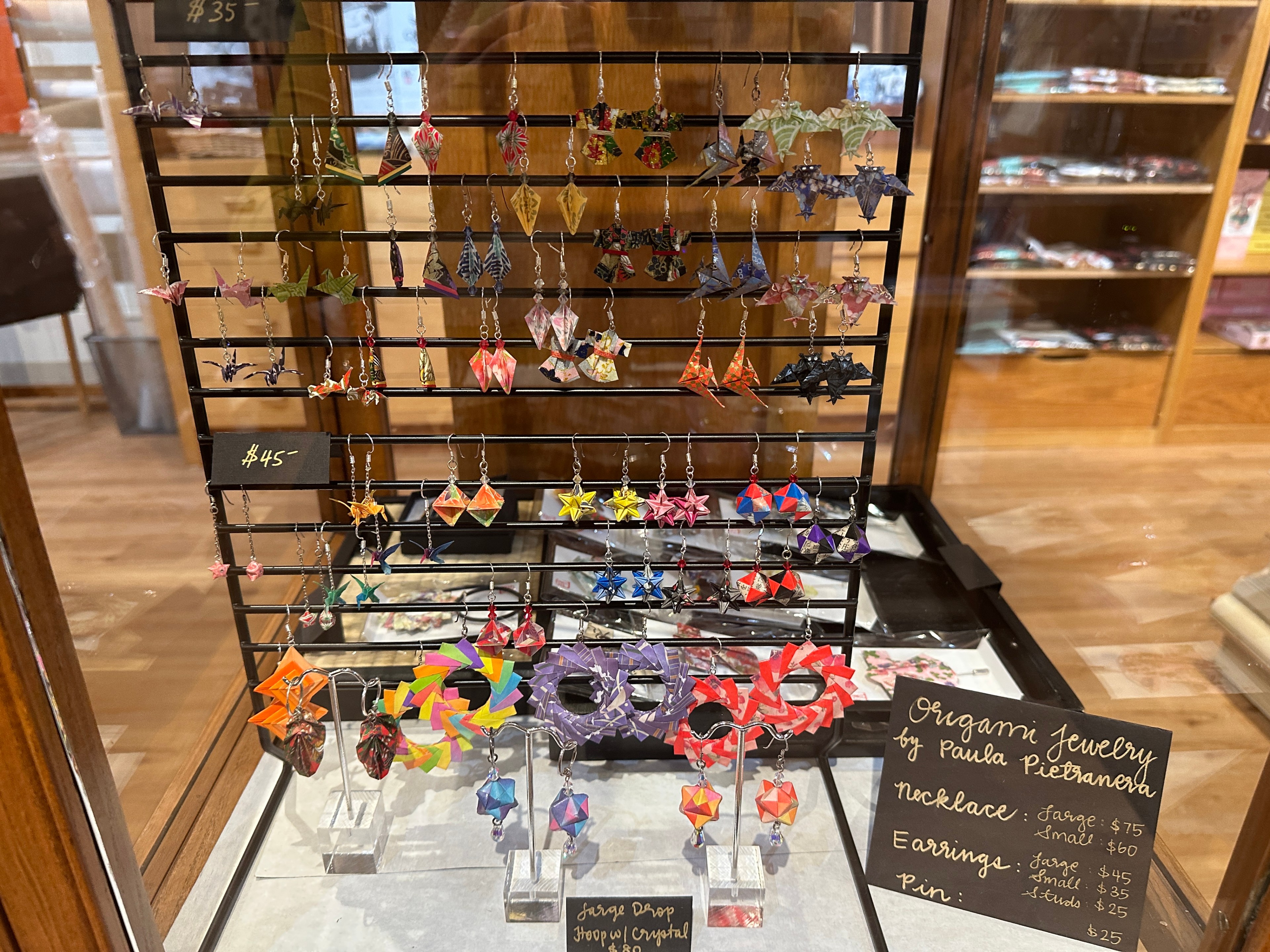Origami paper earrings hang in a display in a Japantown paper store.