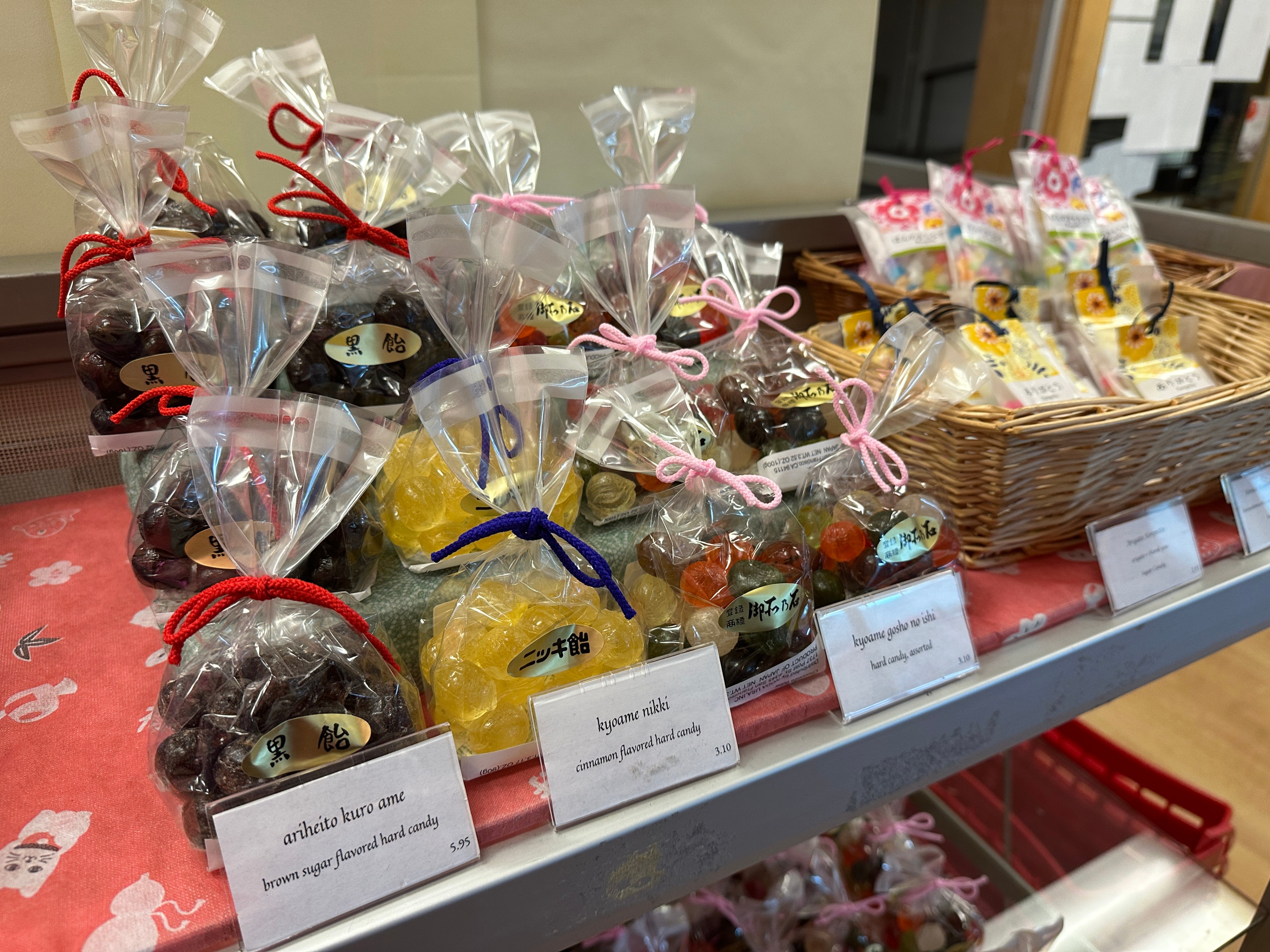 Colorful hard candies sit in rows and baskets on display at a Japantown sweets store.  