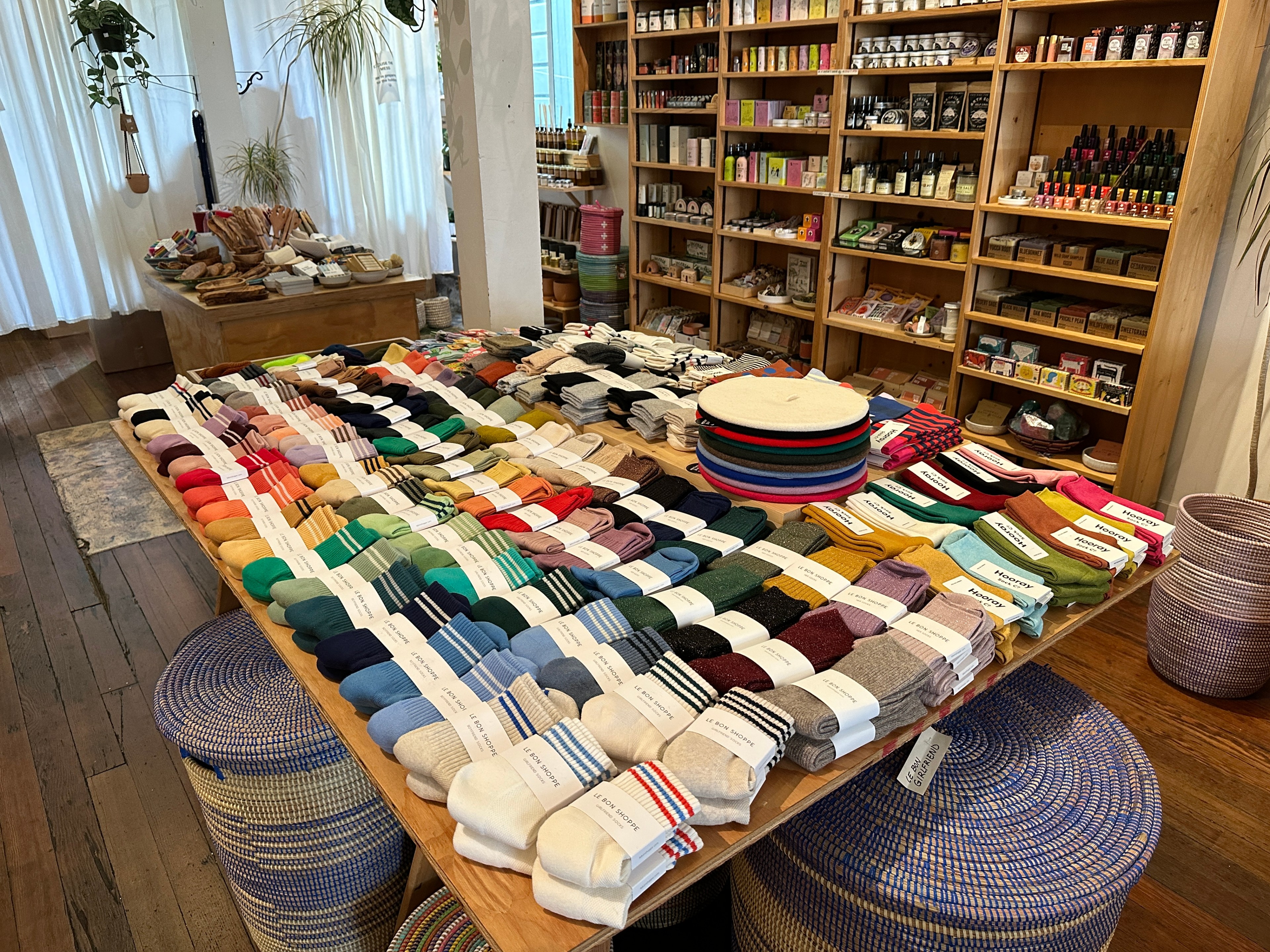 Bundles of colorful socks lie on display in a boutique gift shop.