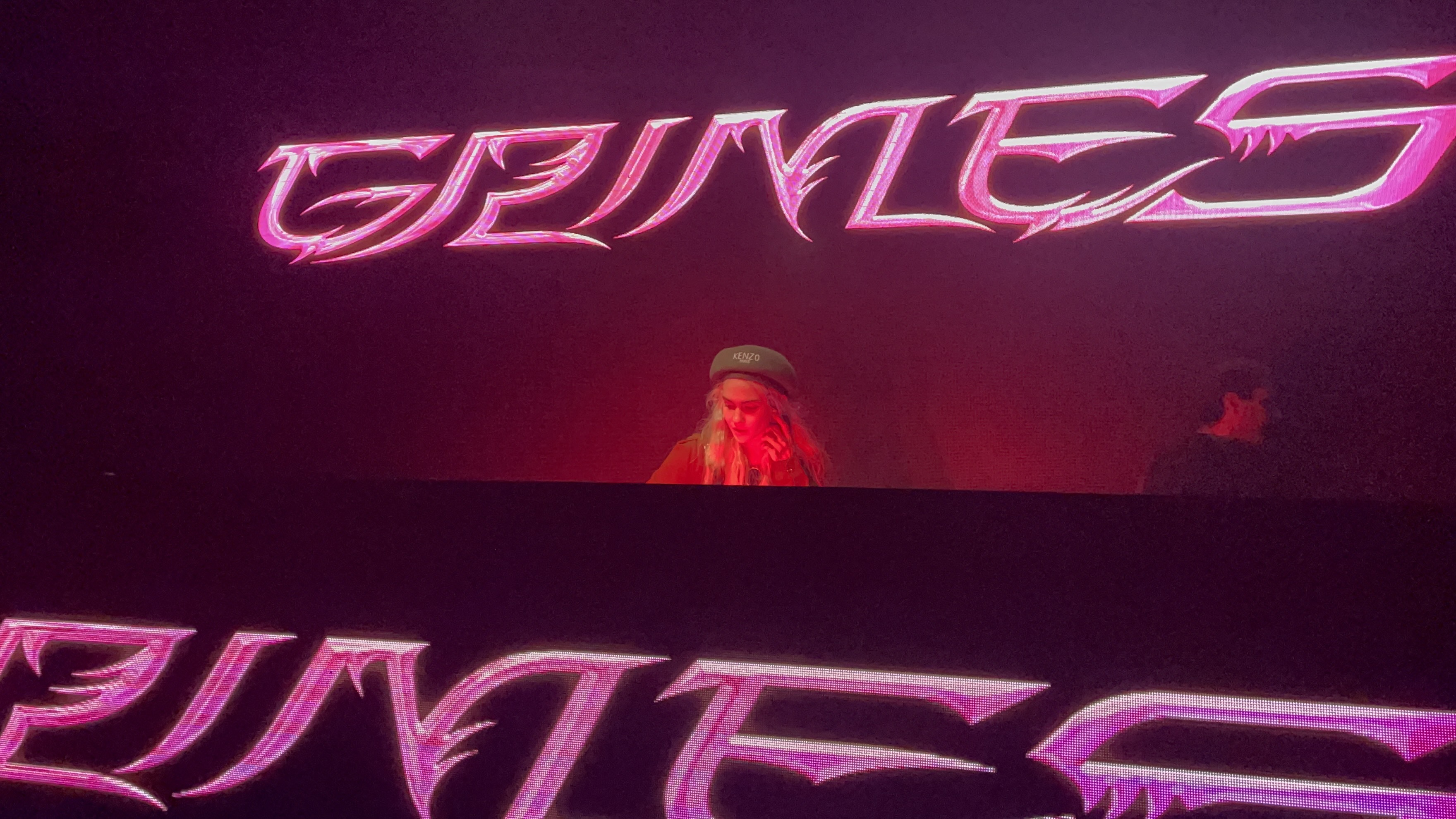 A woman DJs behind a booth in a San Francisco nightclub.