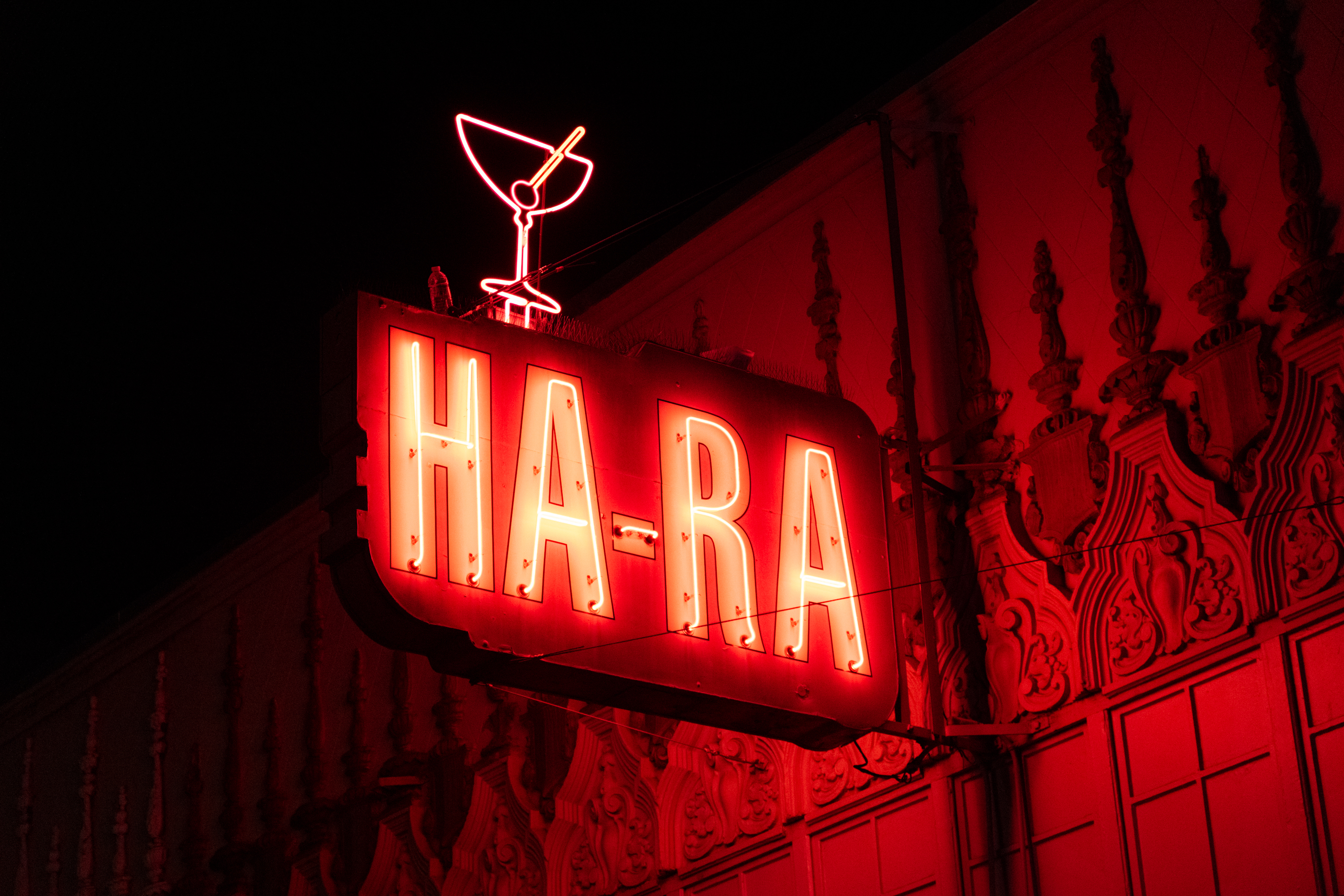 A red neon sign at night with the words &quot;Ha-Ra&quot;