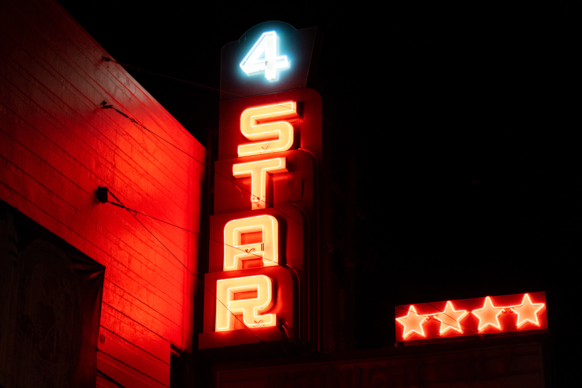 A neon sign at night with the words &quot;4 STAR&quot;