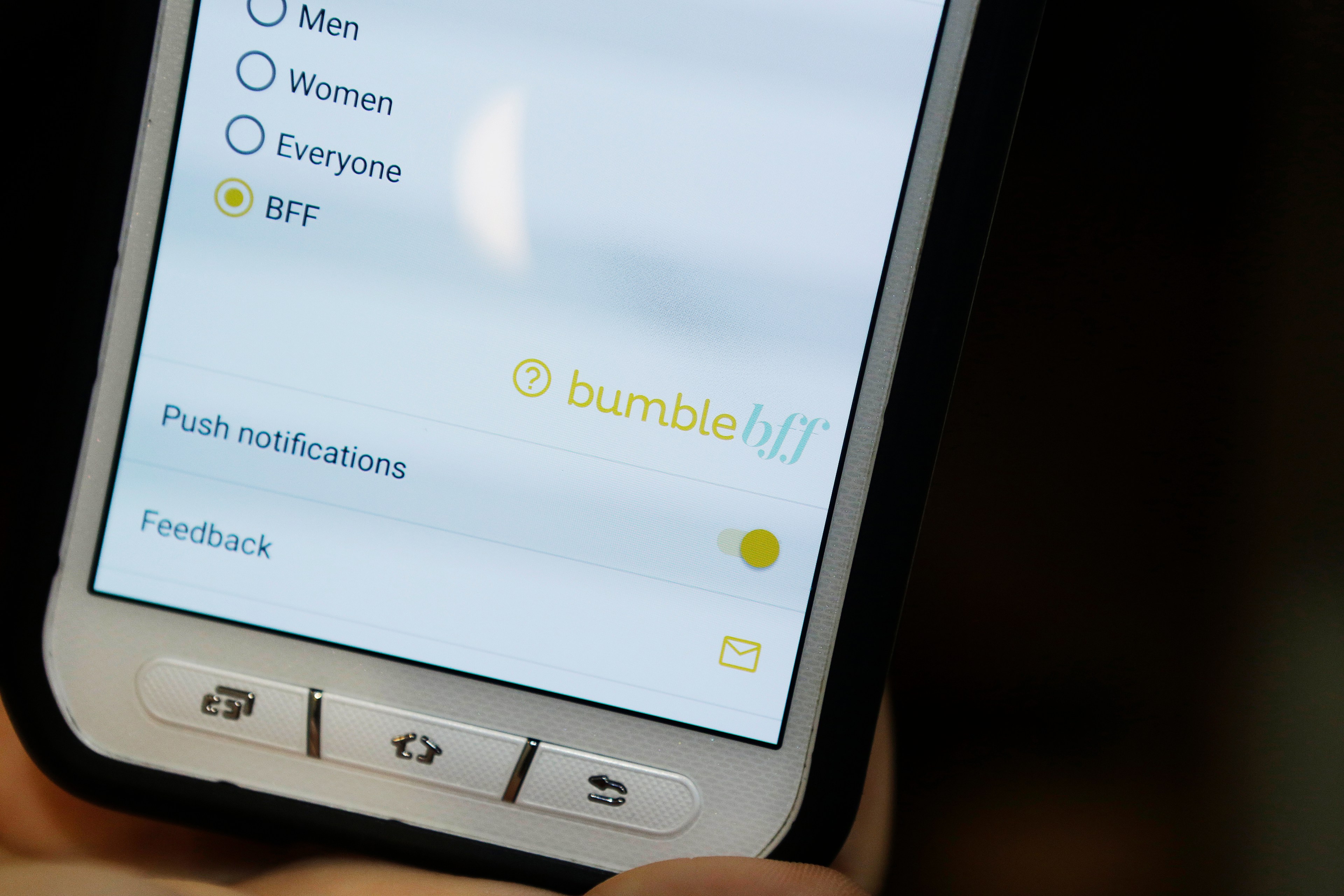 A tight image of the bottom of a cell phone detail of the mobile photo app, Bumble BFF, where people can find friends or in some cases, BFFs.