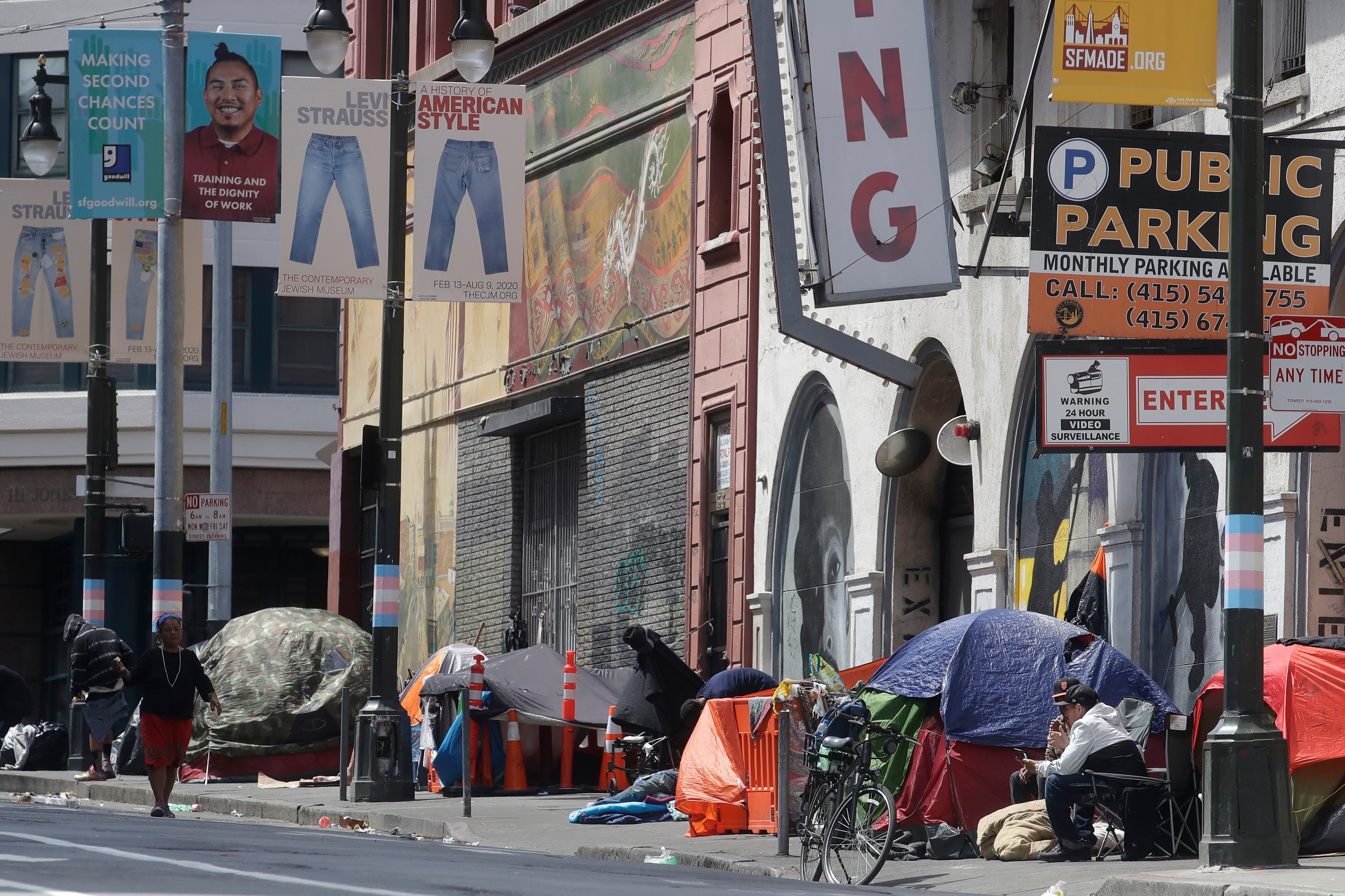 A long homeless encampment on a city street.